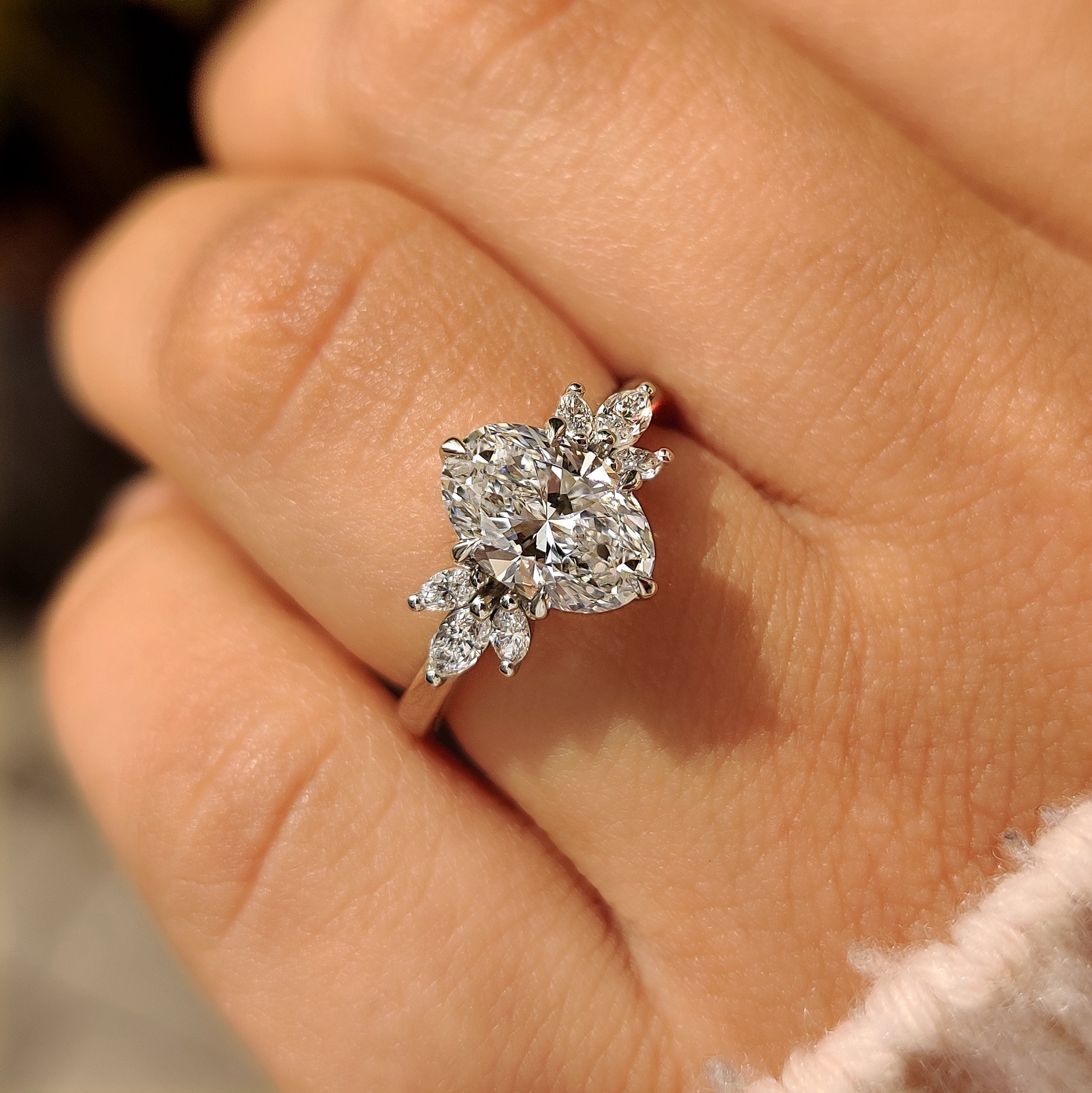 Oval cut lab diamond ring with marquise side stones
