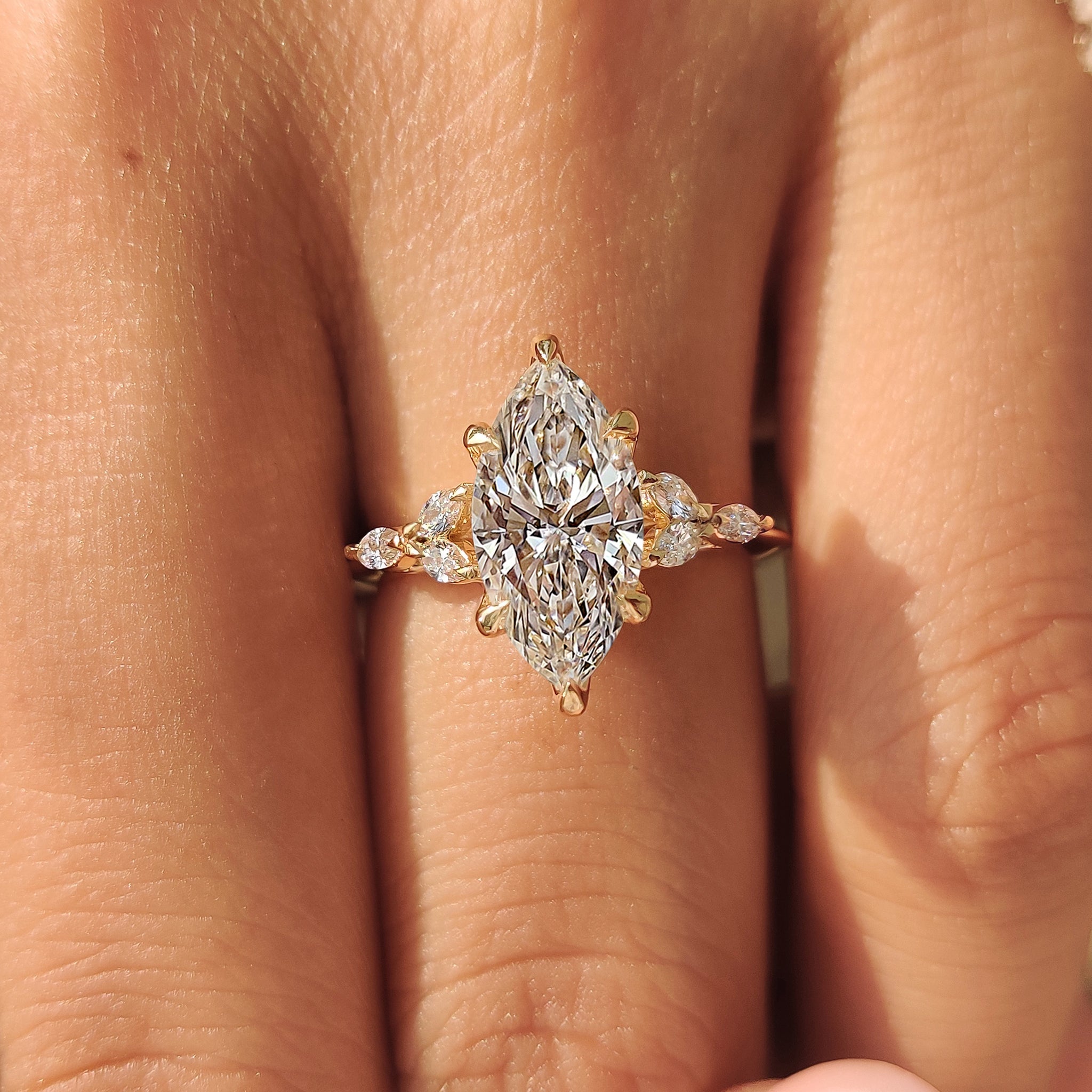 Marquise diamond ring with side stones in muse setting
