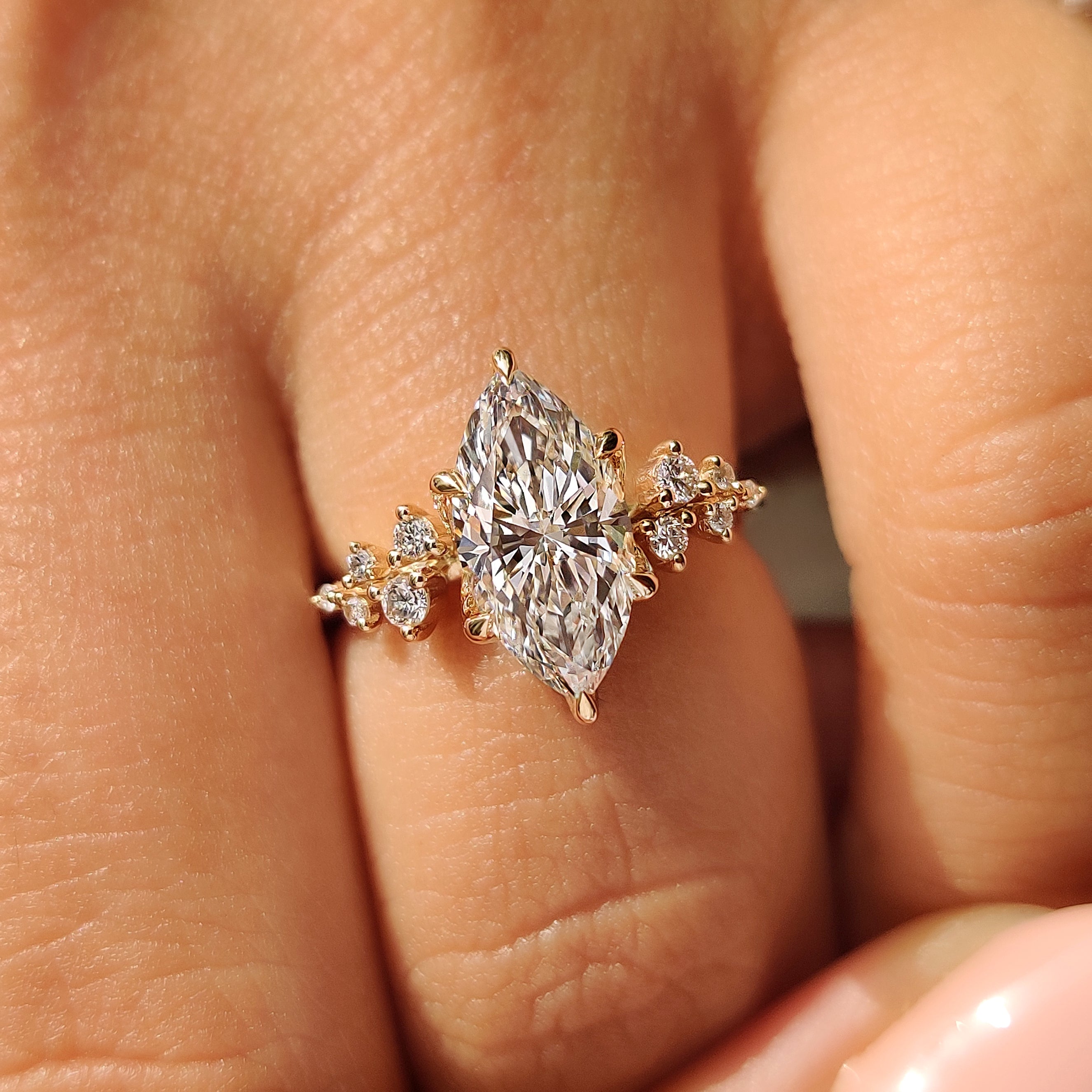 Marquise Engagement Ring with round side stones and tulip setting
