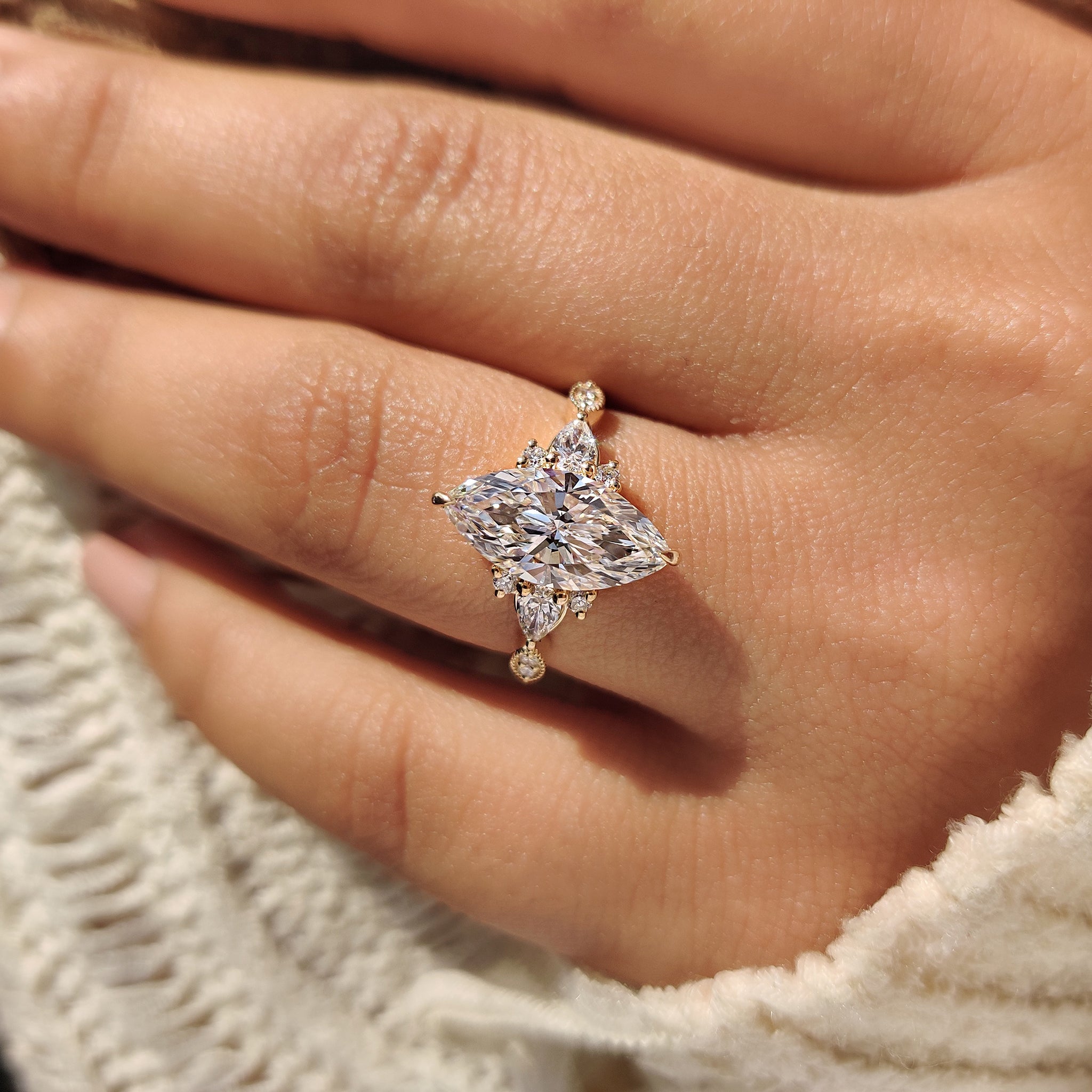 Marquise ring with pear accents and round side diamonds.

