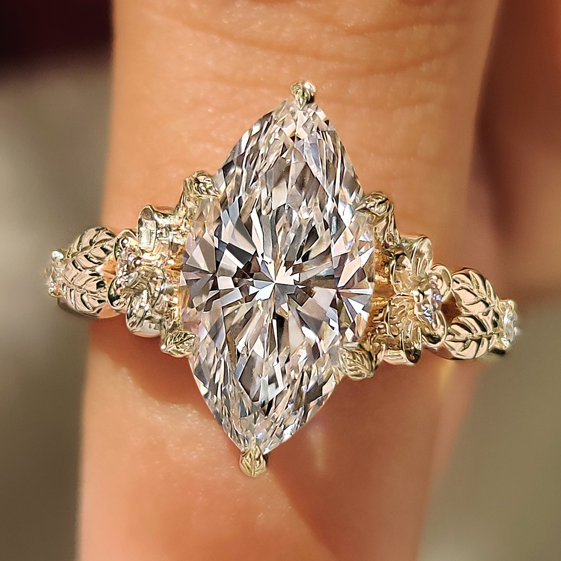 Marquise cut diamond ring with round side stone accents
