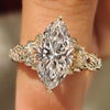 Marquise cut diamond ring with round side stone accents
