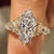Marquise cut diamond ring with round side stone accents
