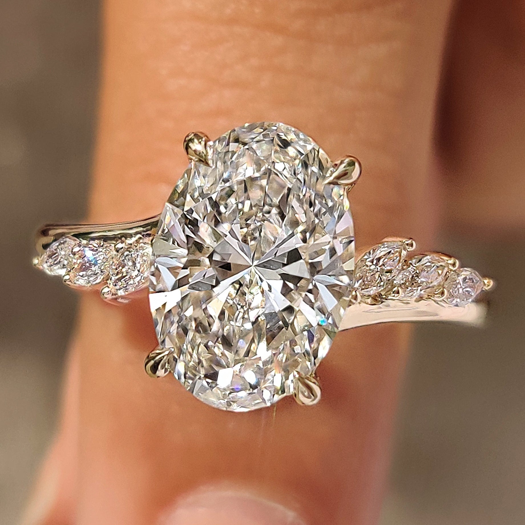 Oval cut center diamond with marquise side stones
