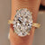 Oval solitaire ring with engraved scrollwork shank.
