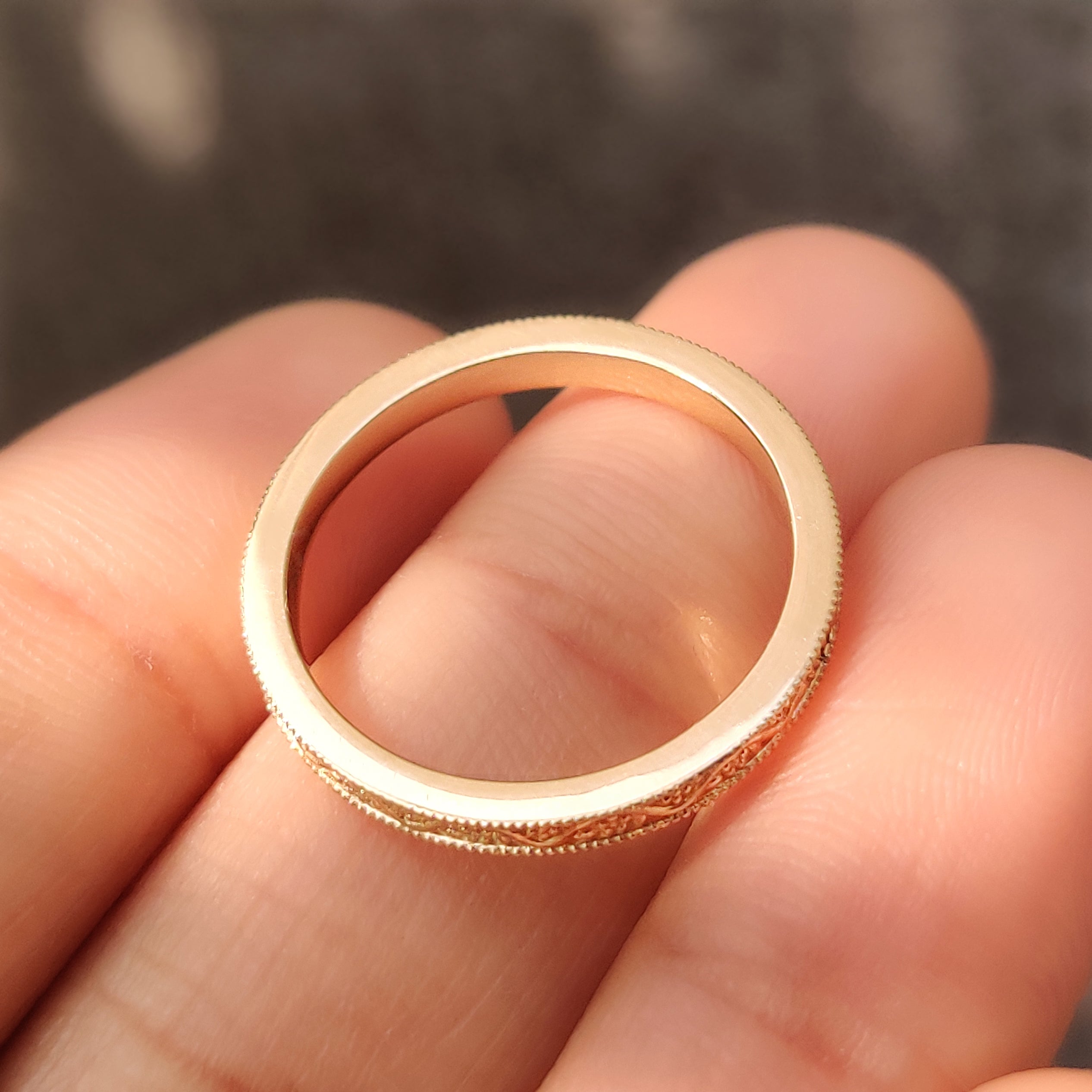 Vine pattern with filigree details on a wedding band.

