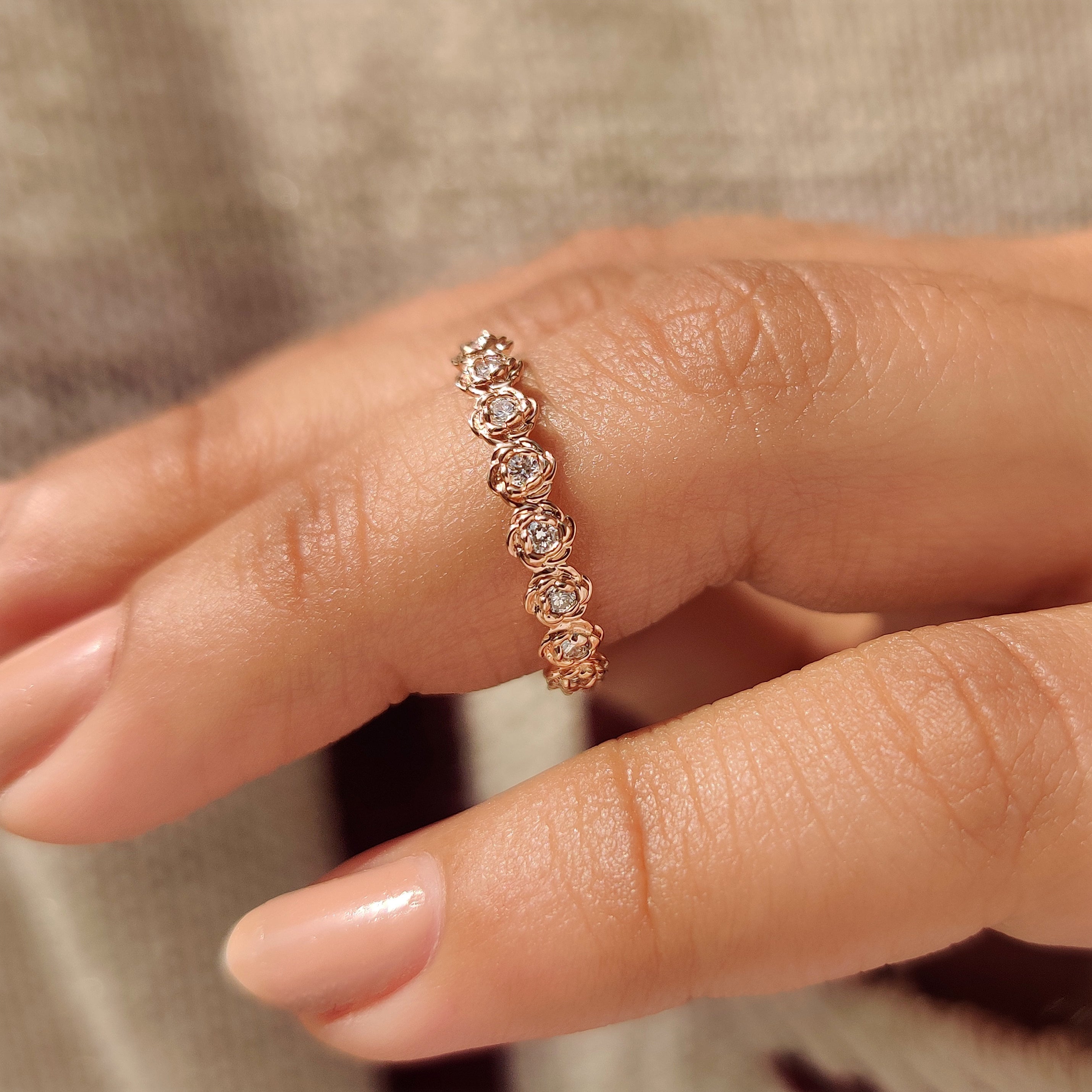 Round diamond wedding band with detailed flower inspired design.
