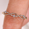 Round diamond wedding band with leaf and vine design
