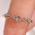 Round diamond wedding band with leaf and vine design
