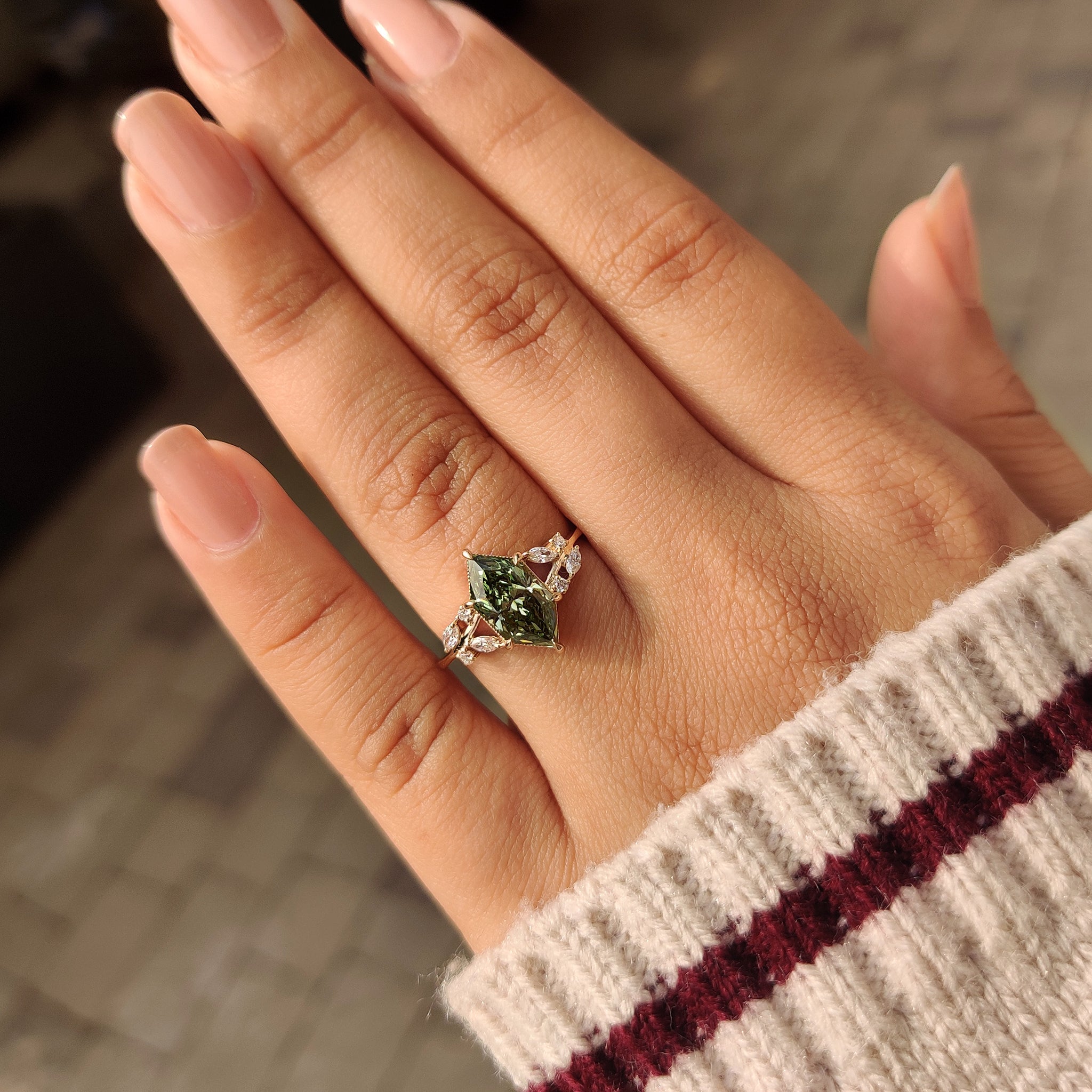 Handmade green diamond ring with nature inspired design.
