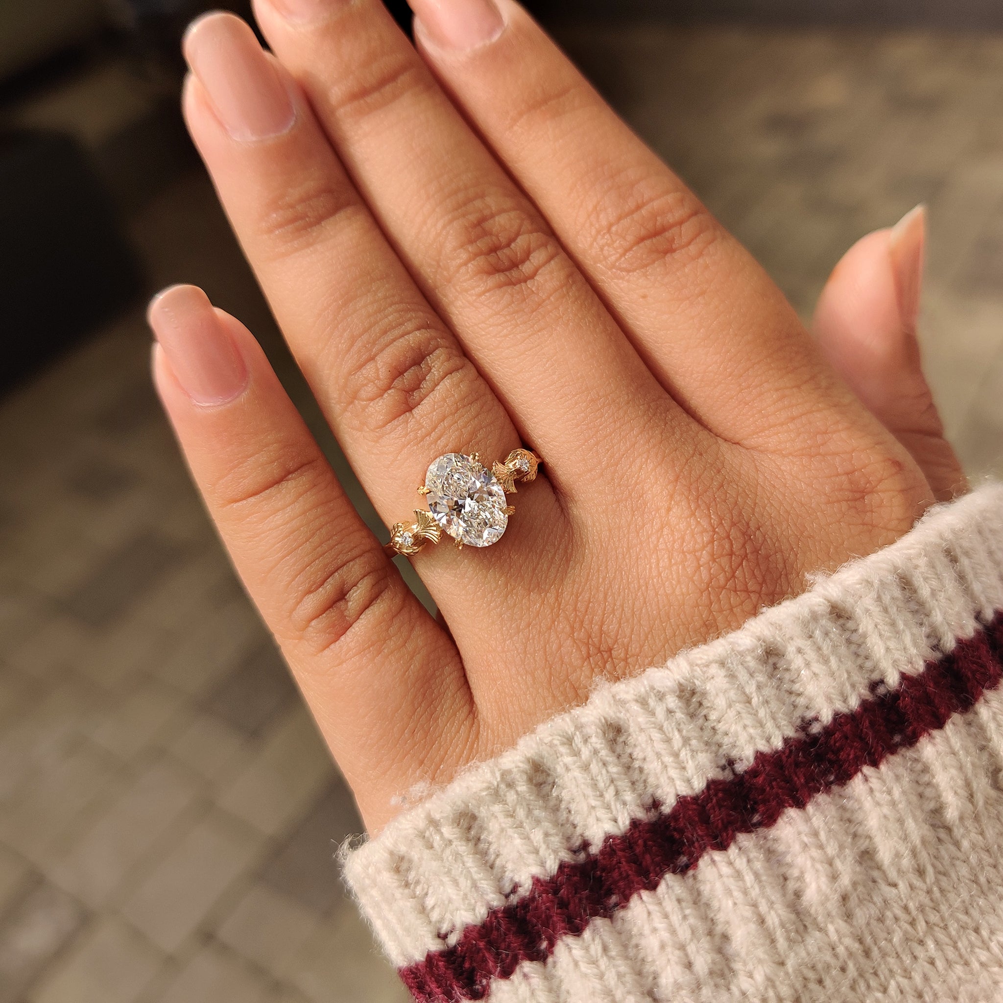 Oval diamond ring featuring round side stones
