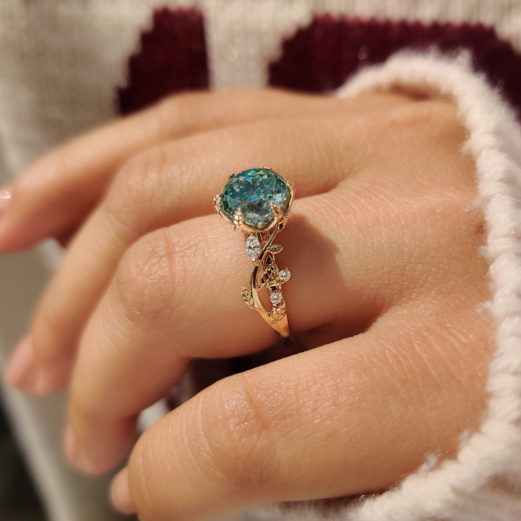 Handmade cyan blue moissanite ring with six leaf prong.
