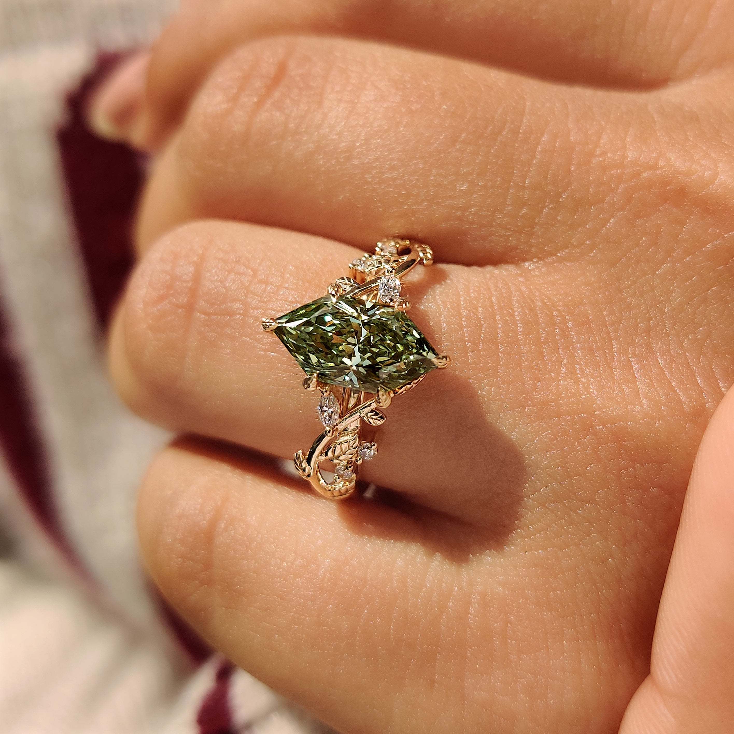 Handmade green diamond ring with marquise side stone accents
