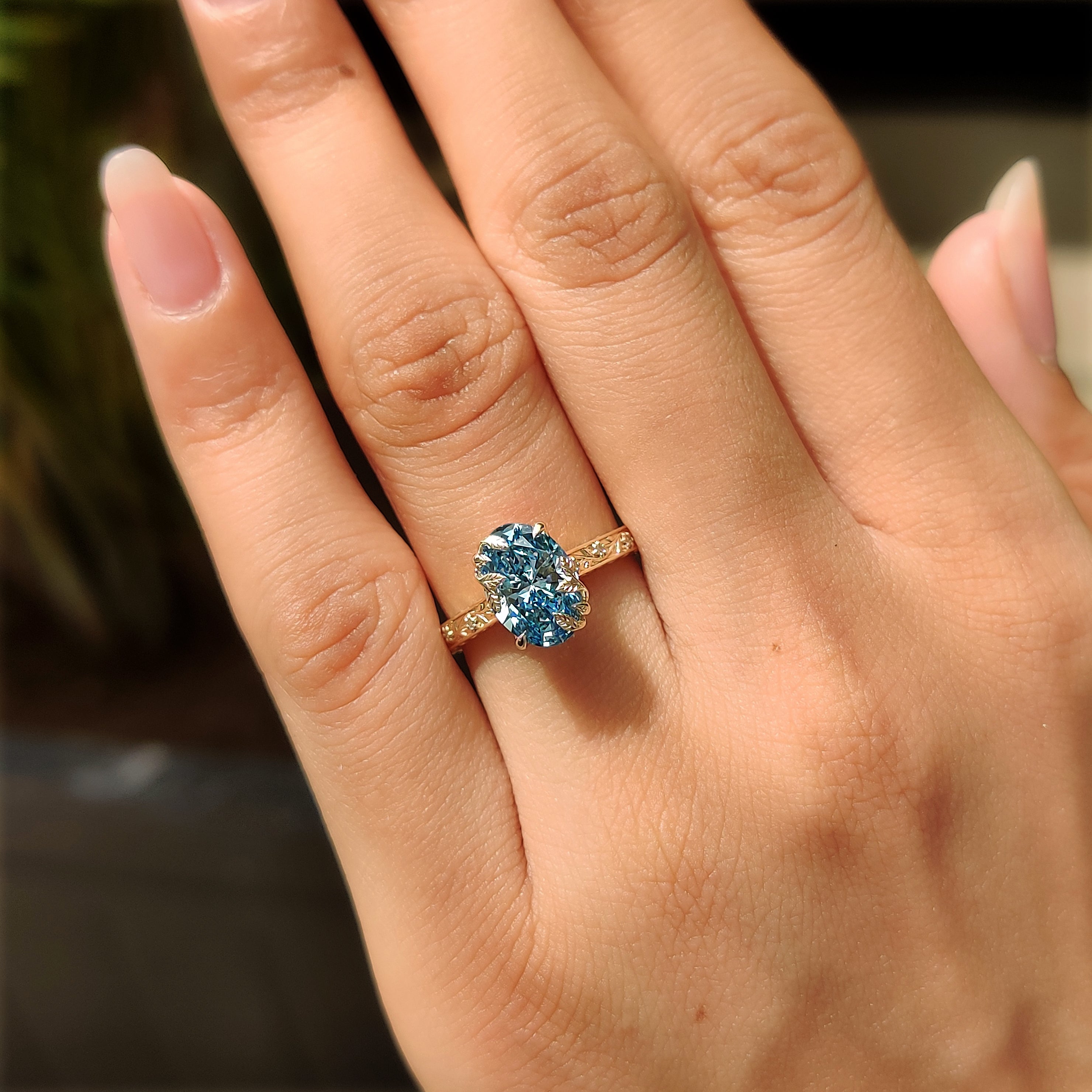 Handmade oval engagement ring with floral design
