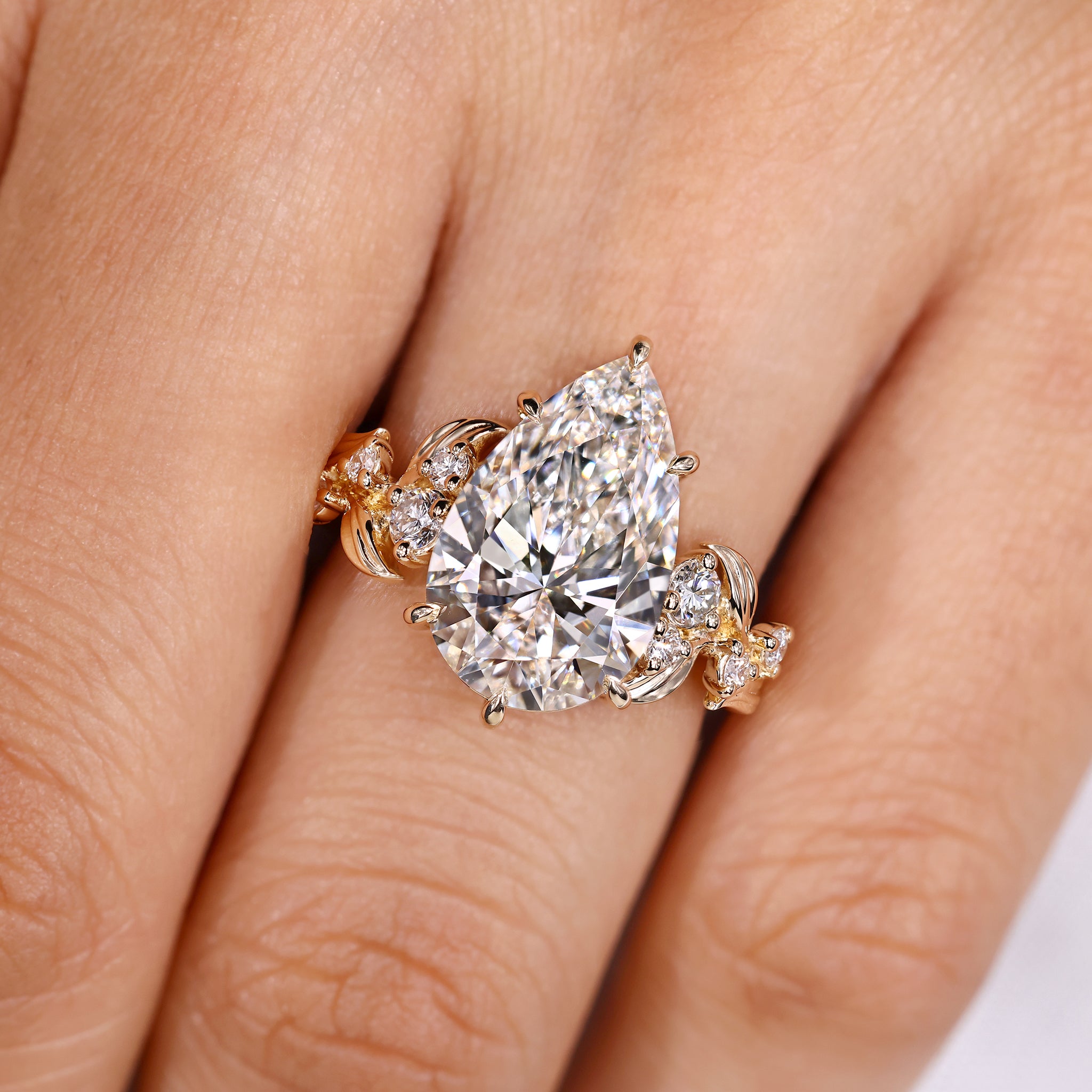 Pear shaped diamond ring with round side stones
