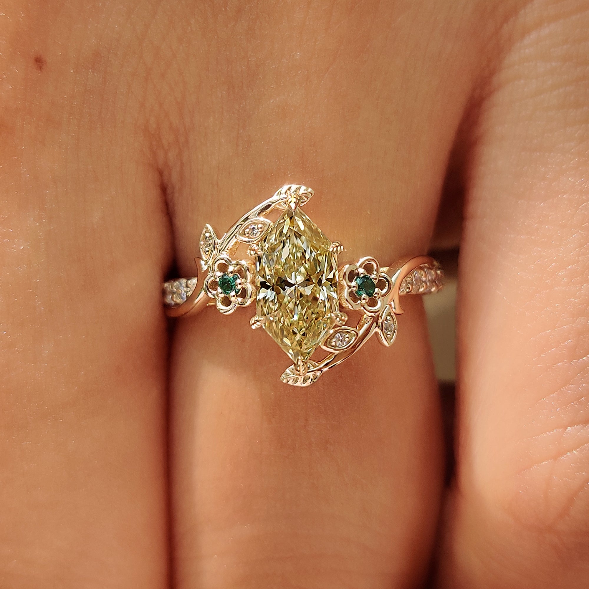 Leaf and vine detailing across a nature inspired engagement ring.
