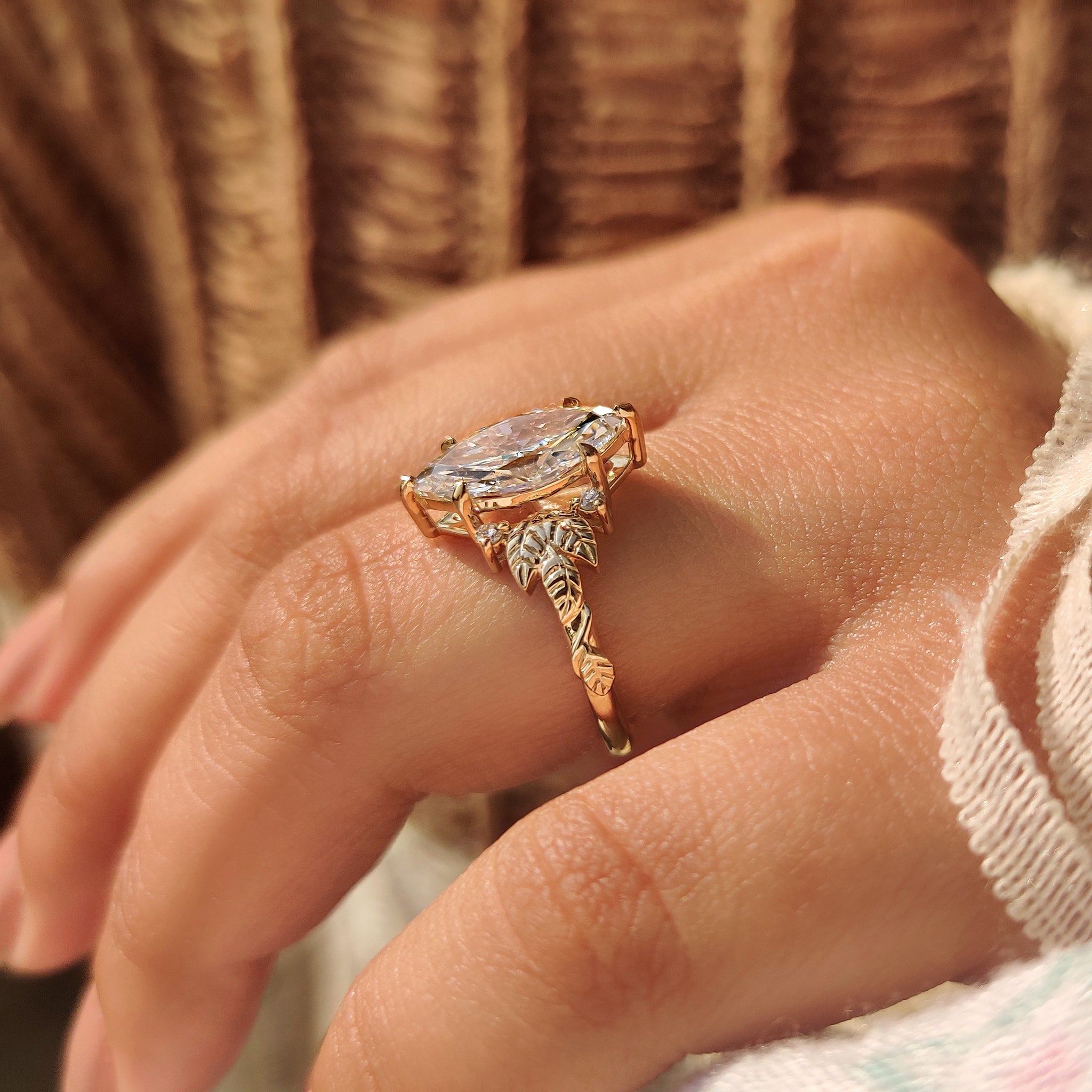 Lab grown diamond ring with marquise cut and leaf shank.
