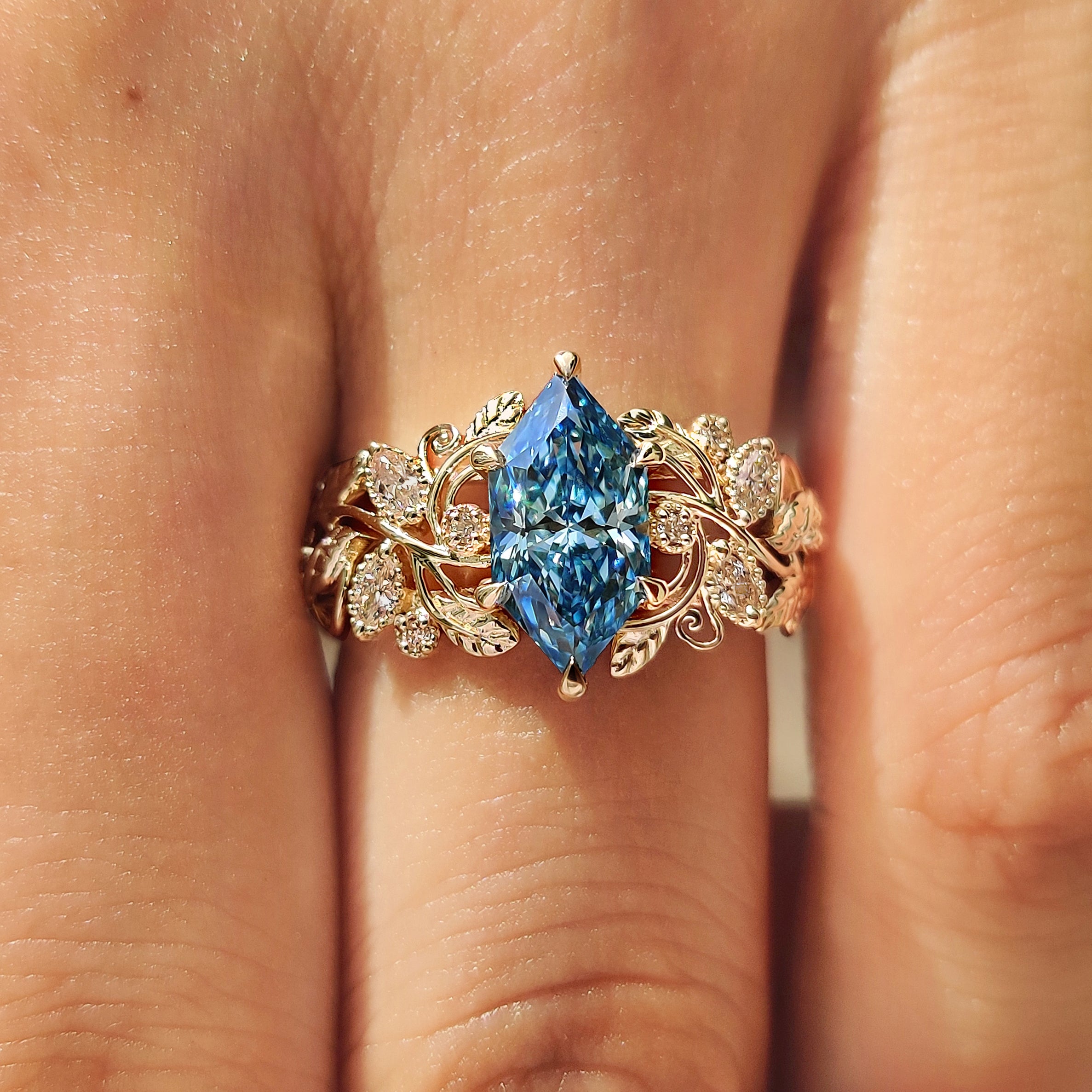 Floral details on blue Dutch marquise engagement ring
