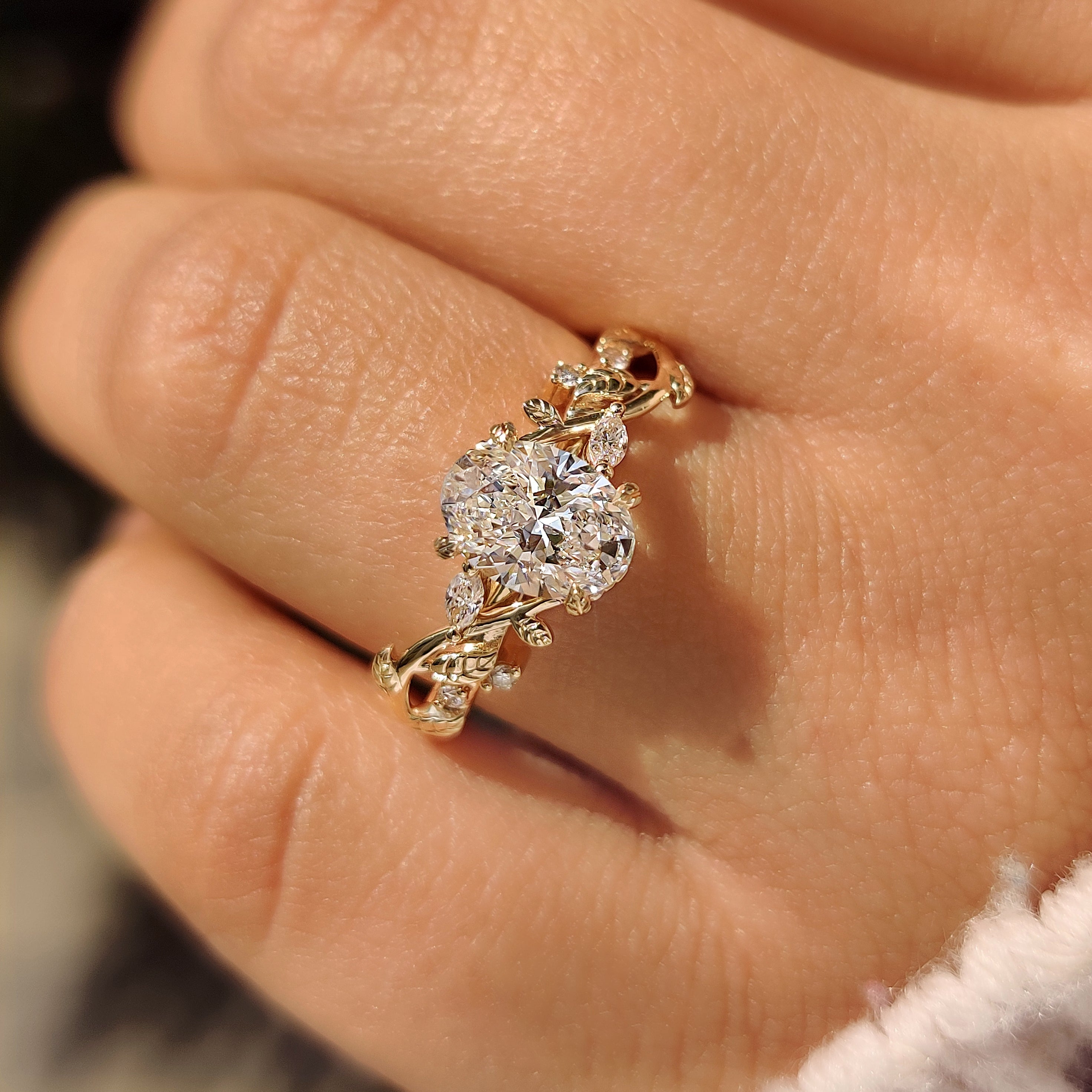 Nature style oval diamond ring with four leaf prongs.
