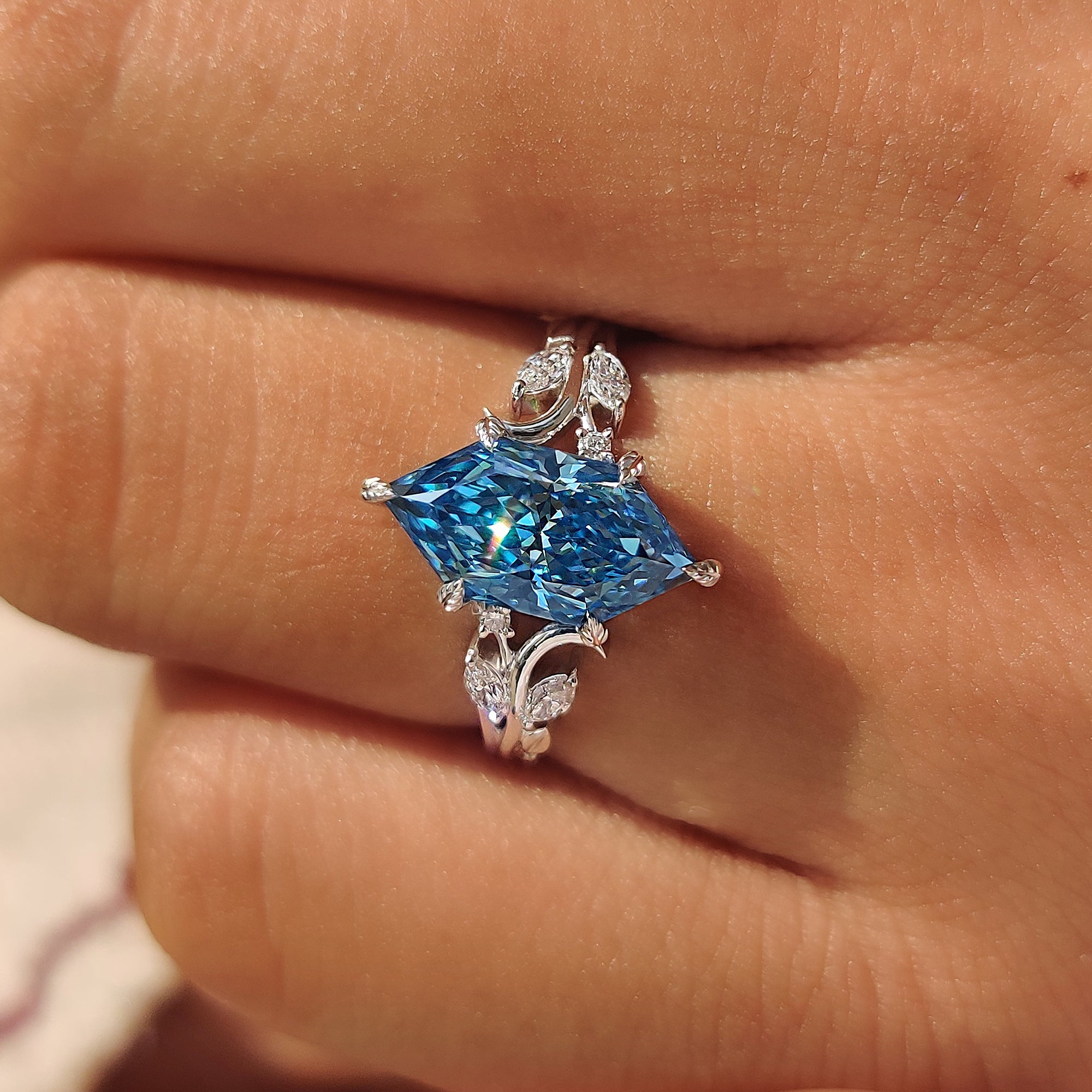 Marquise and round side stones with blue Dutch marquise center diamond.
