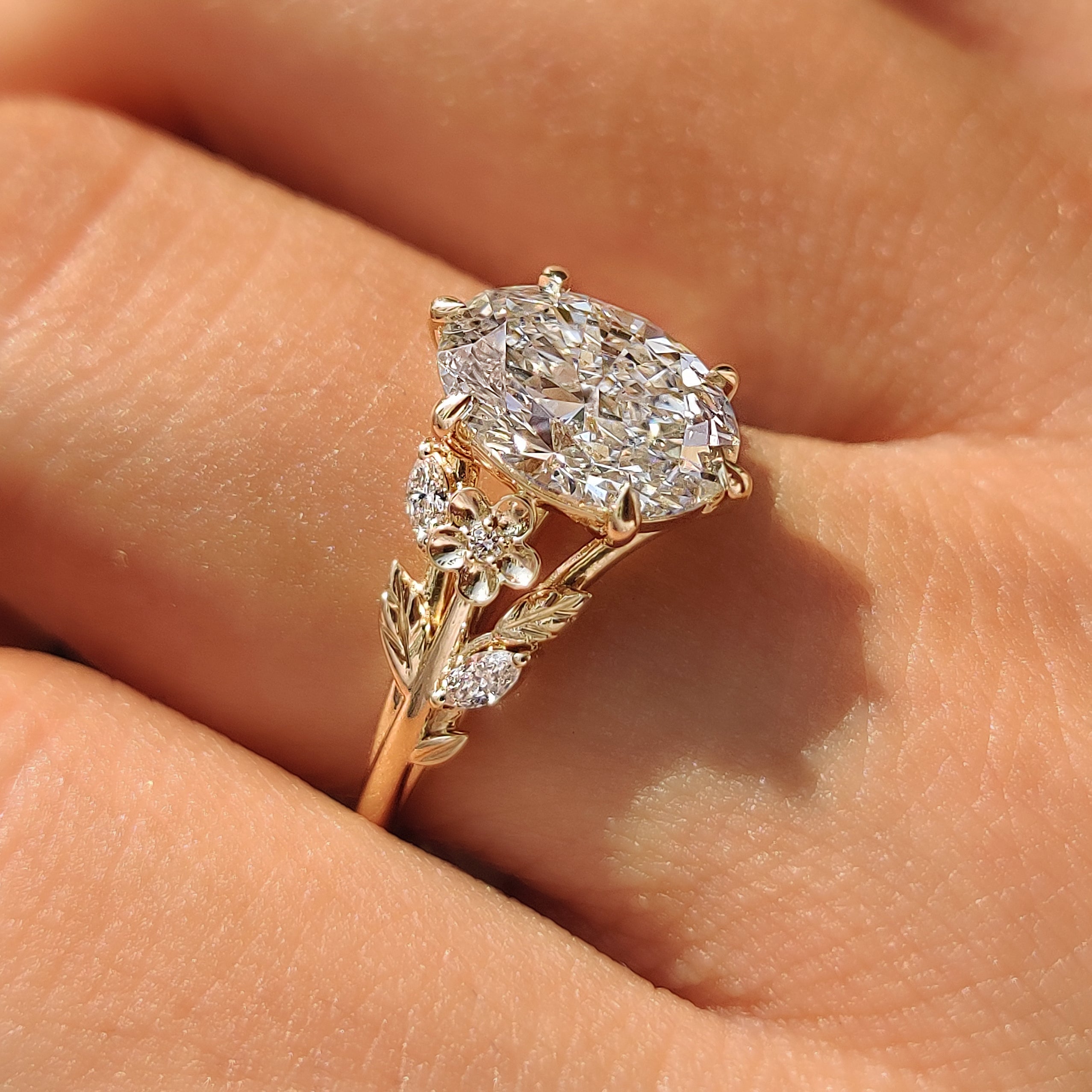 Oval cut lab grown diamond in a cathedral profile setting.
