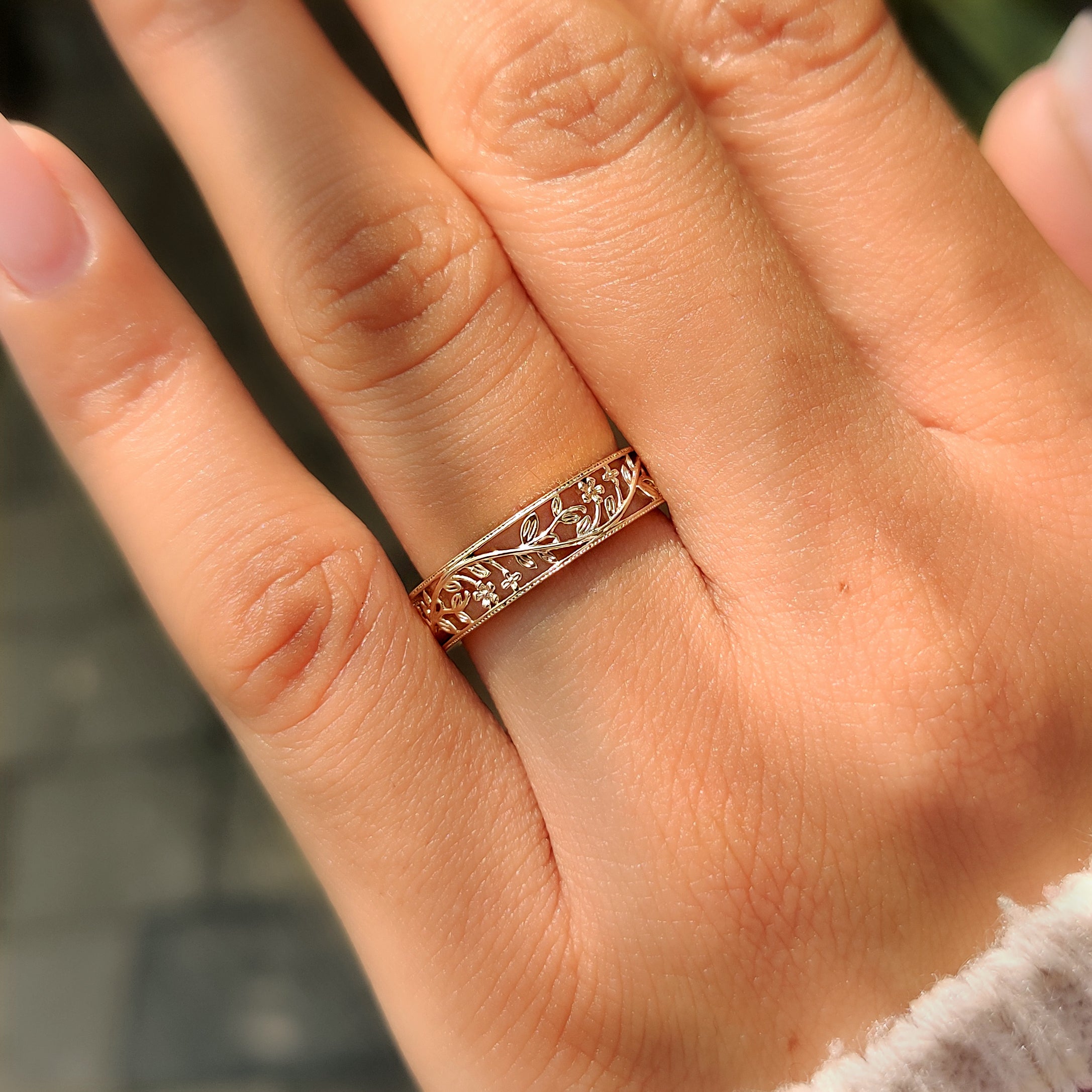 Nature inspired wedding band with small flower motifs.
