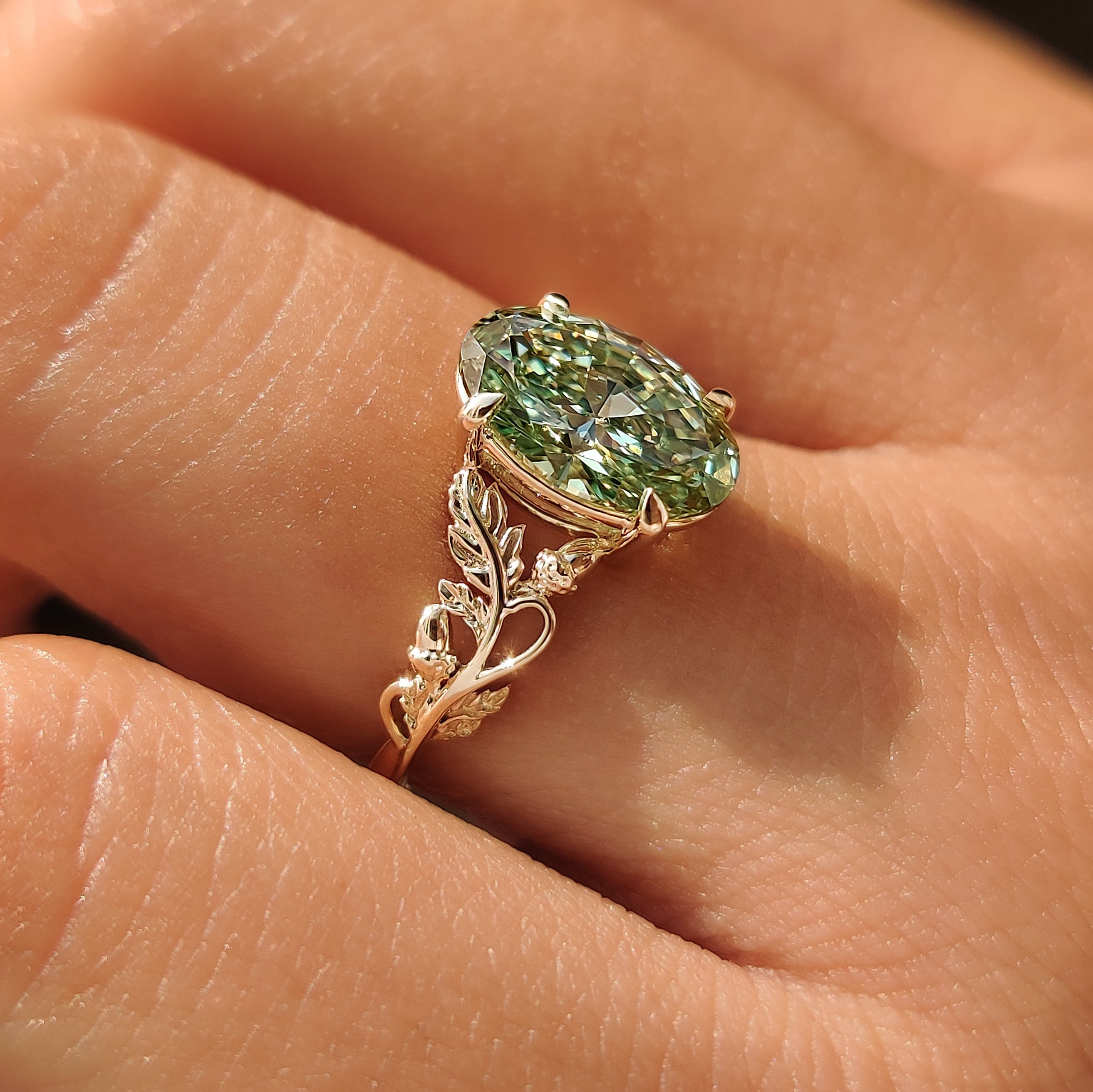Nature inspired solitaire engagement ring with leaf details.
