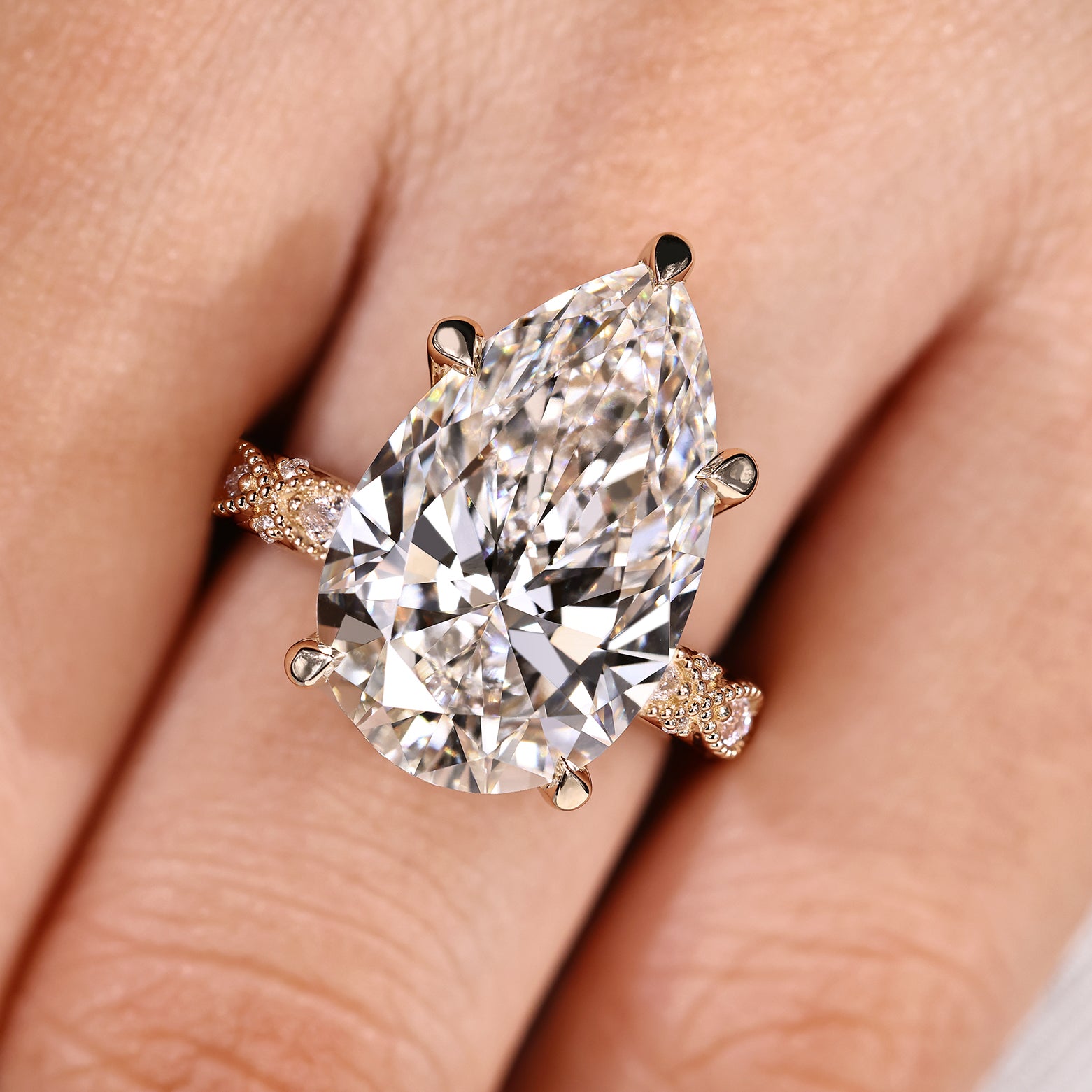 Pear shaped diamond ring with five claw prong setting
