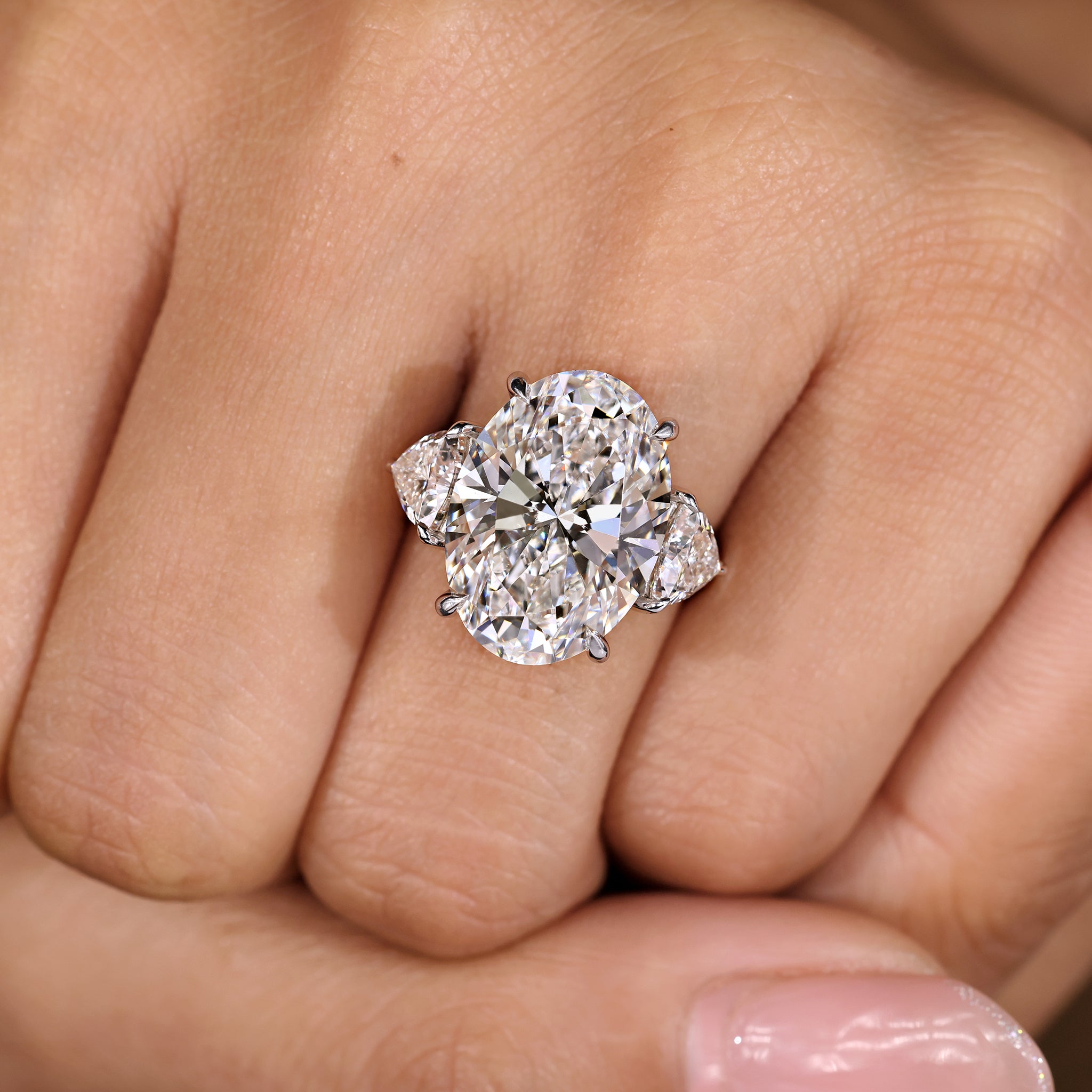 Oval diamond ring with four claw prong setting
