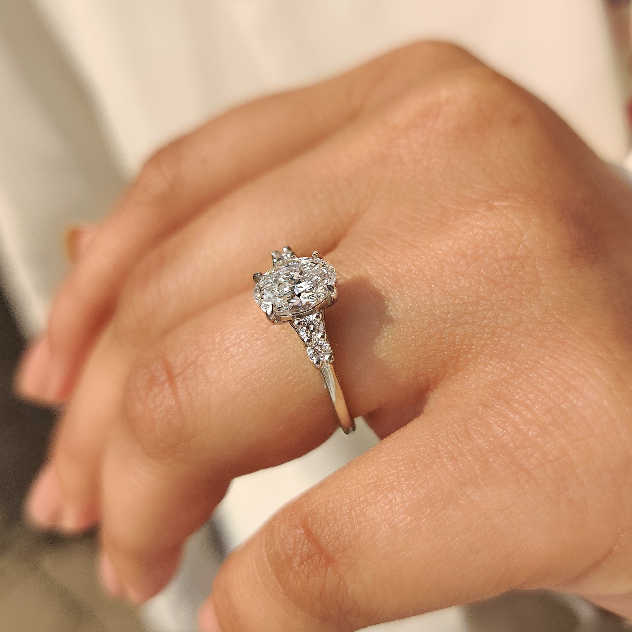 Lab grown oval diamond ring with side accents.
