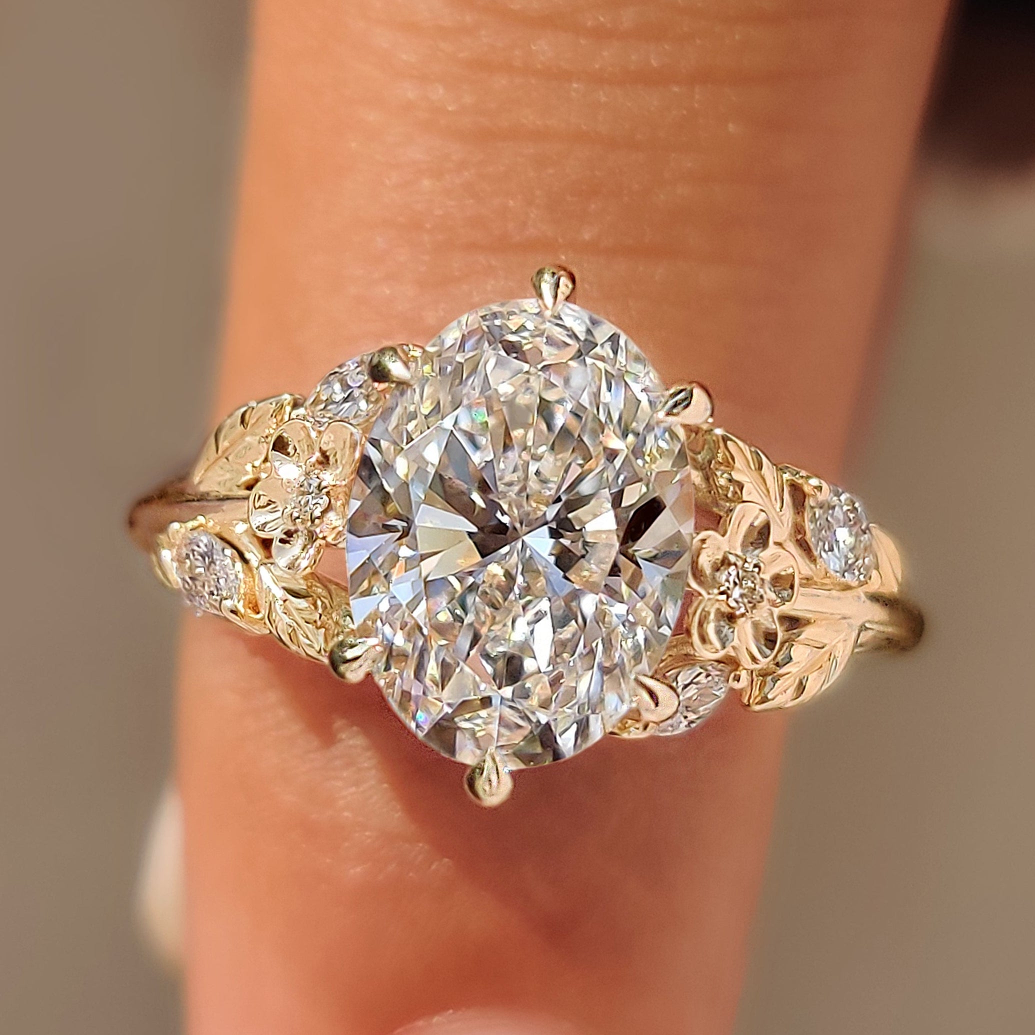 Cherry blossom ring with oval cut center diamond.

