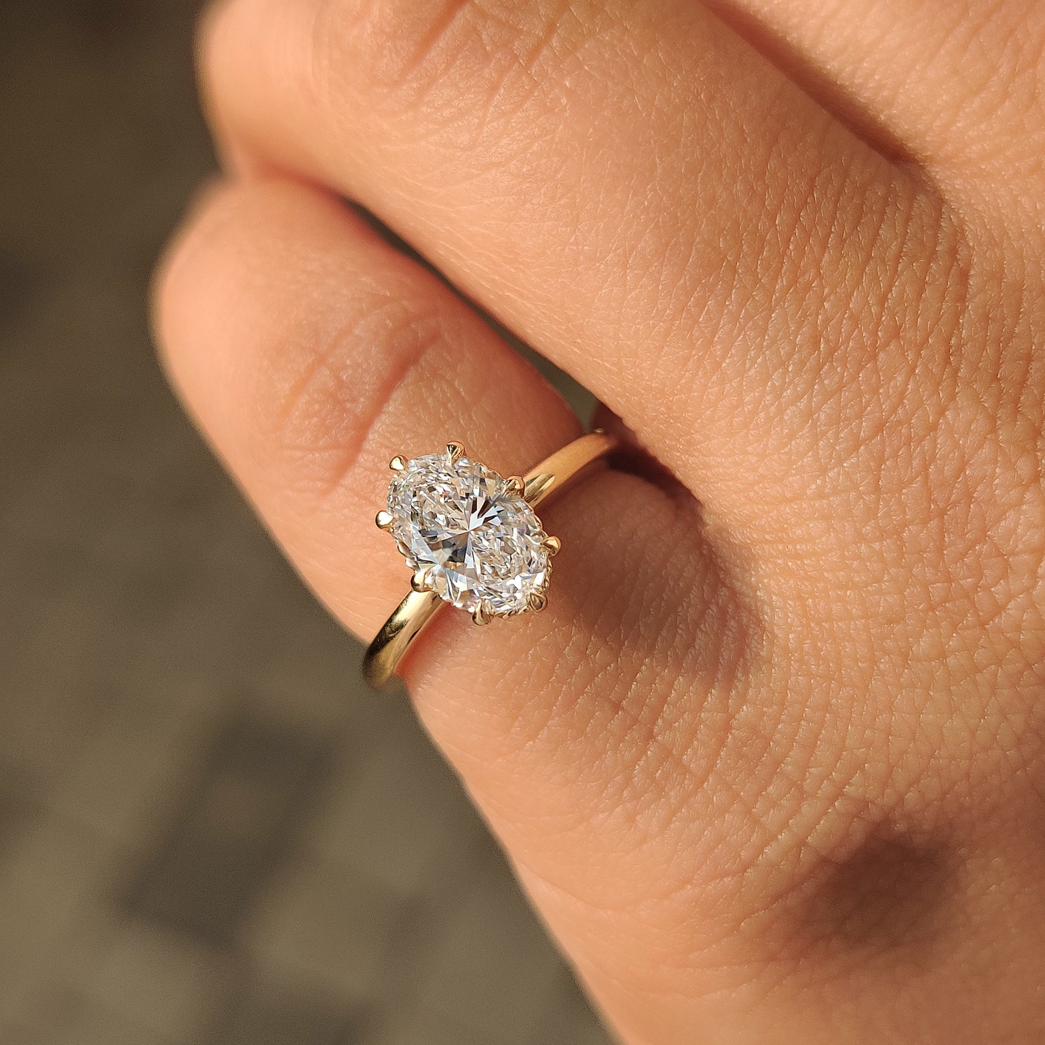 Solitaire oval engagement ring with eight claw prong setting by Carat Diamonds
