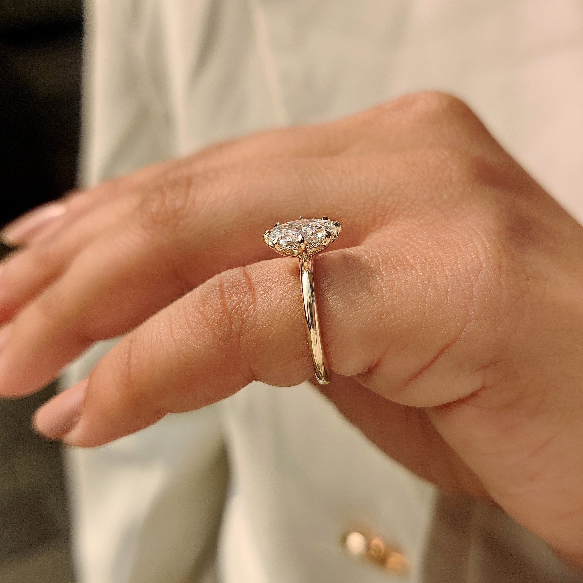 Minimalist solitaire oval engagement ring in eight claw prong setting
