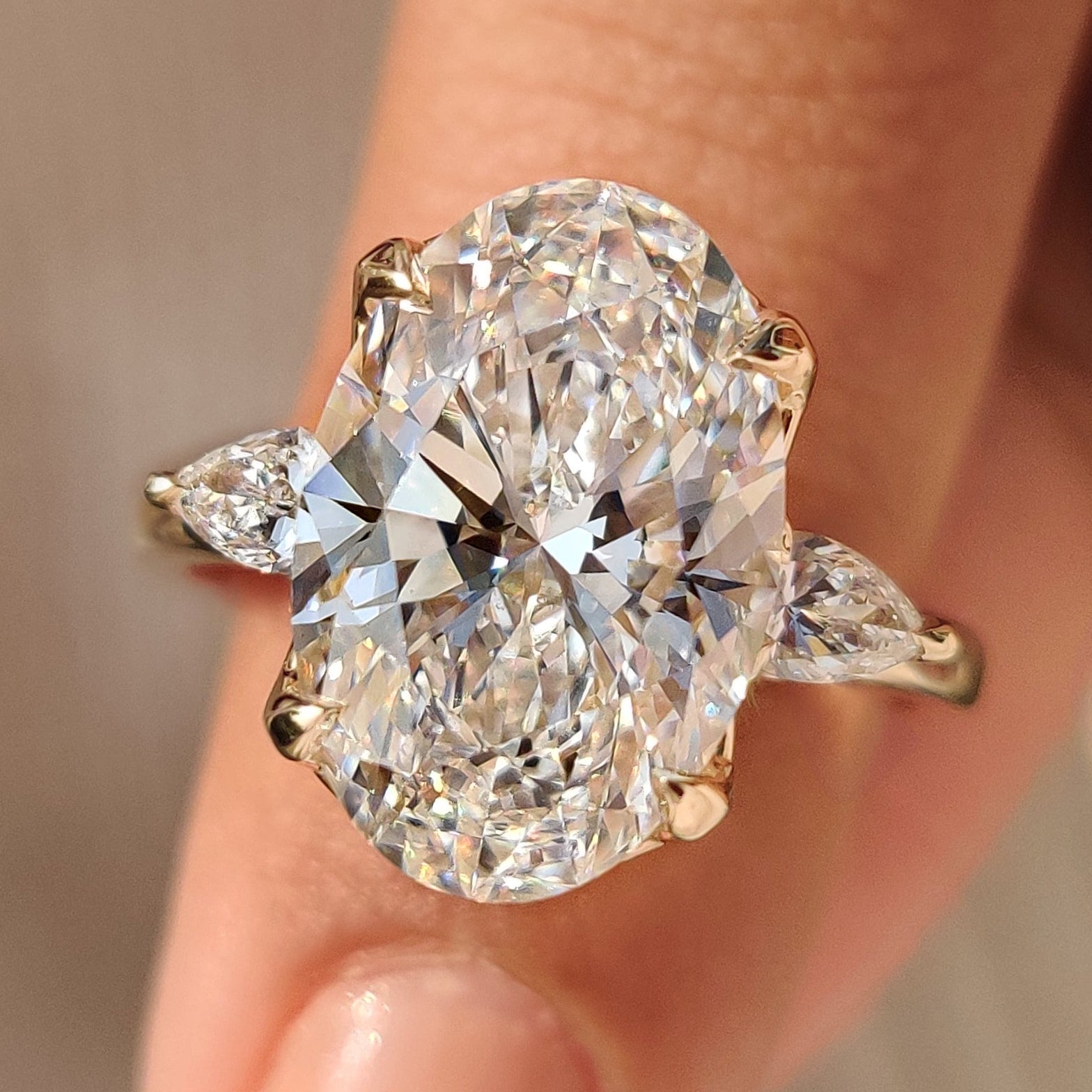 Three stone engagement ring with oval and pear diamonds
