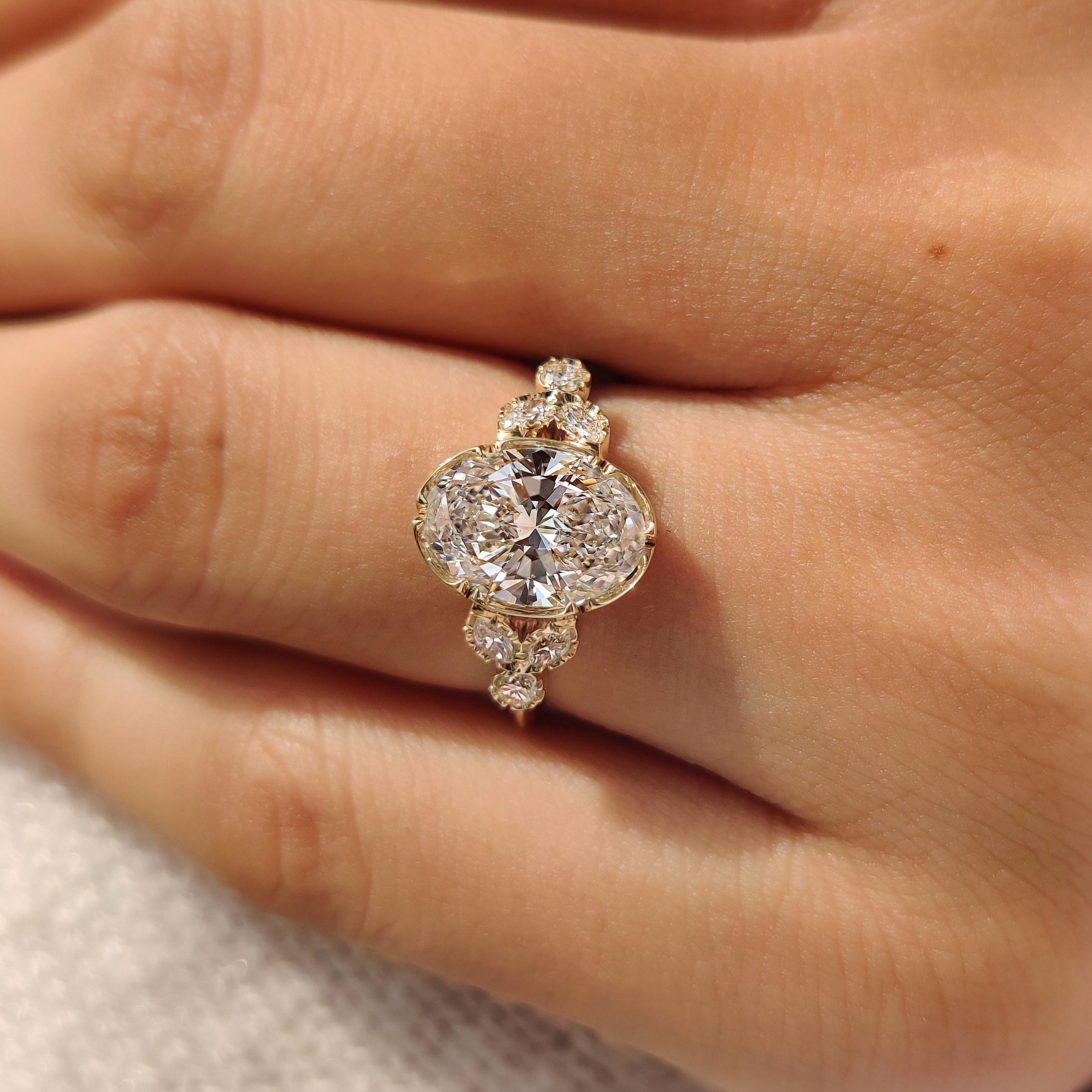 Tulip setting oval ring with side stones
