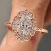 Oval diamond engagement ring with round cut halo setting.
