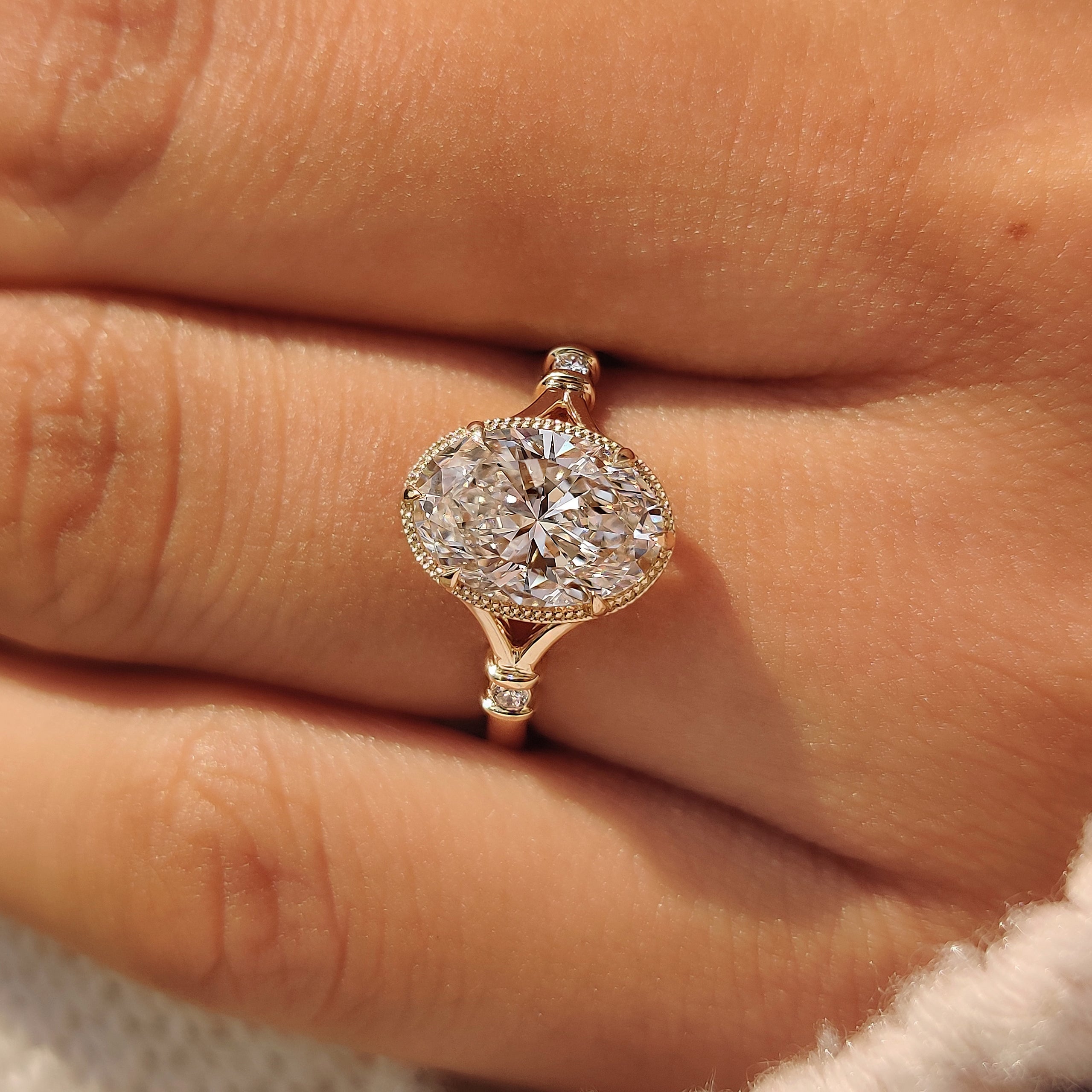 Yellow gold bezel engagement ring with split shank.
