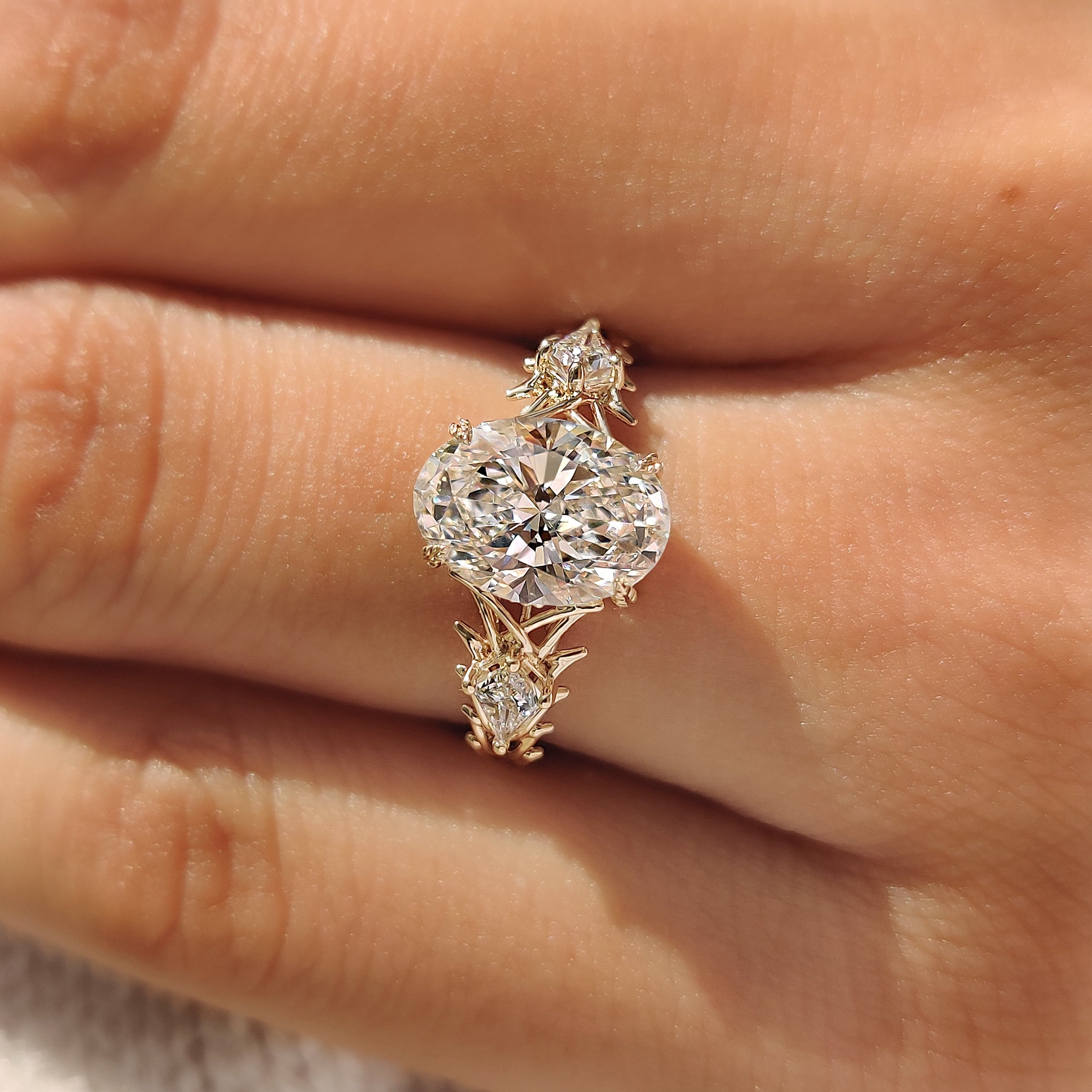 Leaf style prong oval three stone ring
