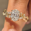 Oval diamond ring with leaf and vine inspired details.
