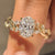 Oval diamond ring with leaf and vine inspired details.
