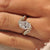 Oval center diamond in bypass ring setting.
