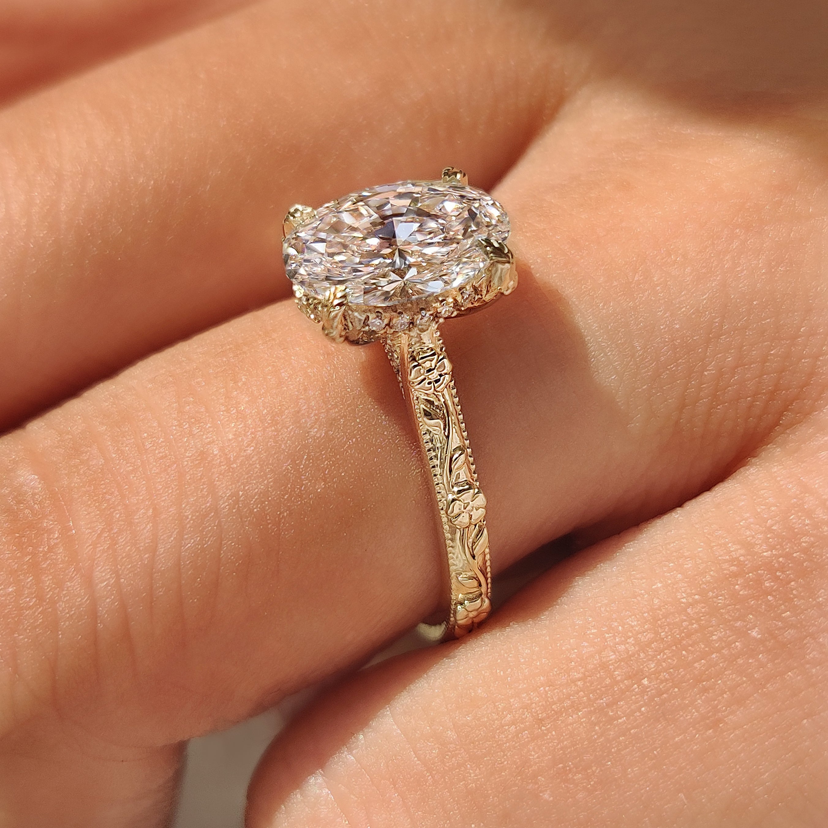 Lab grown oval diamond solitaire engagement ring floral shank.
