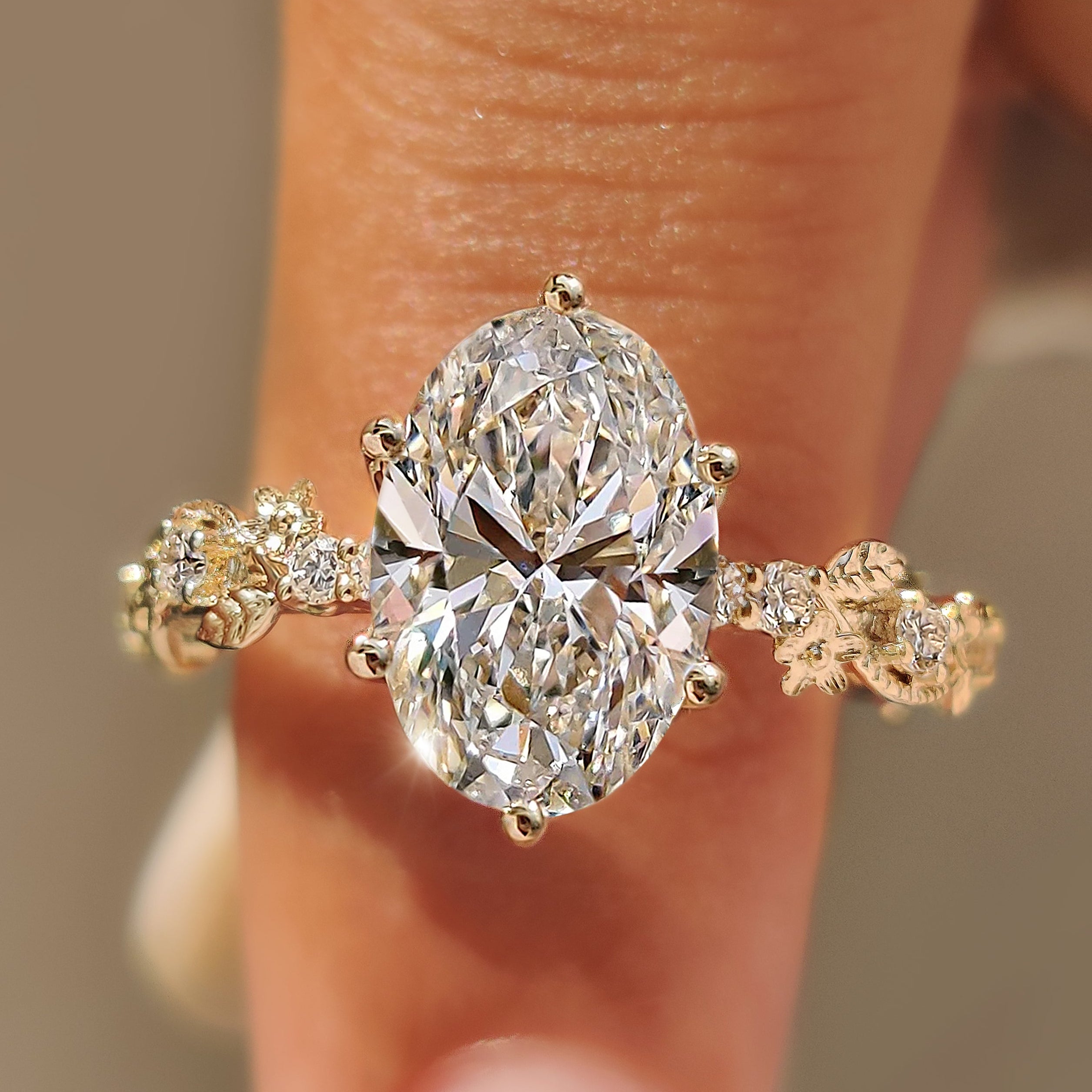 Sakura flower ring with oval center diamond.
