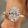 Oval cut diamond ring shines with round cut double side pave band.
