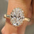Oval cut diamond ring shines with round cut double side pave band.
