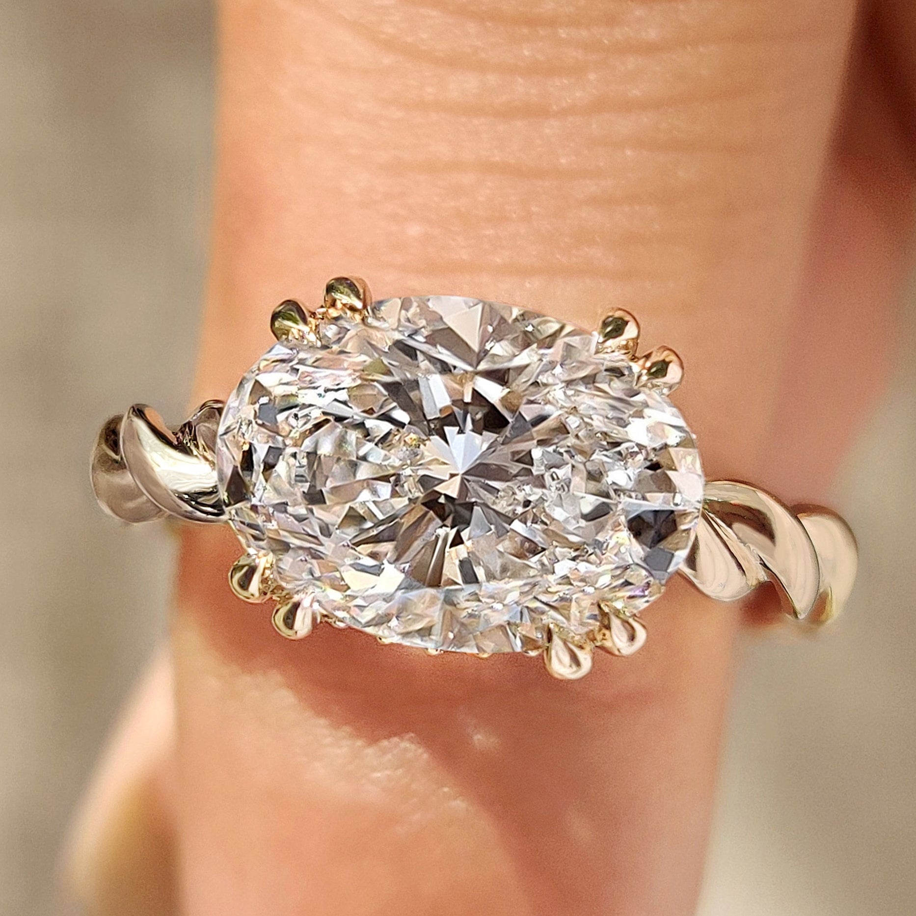 Oval cut engagement ring with twisted shank and hidden halo

