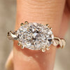 Oval cut engagement ring with twisted shank and hidden halo
