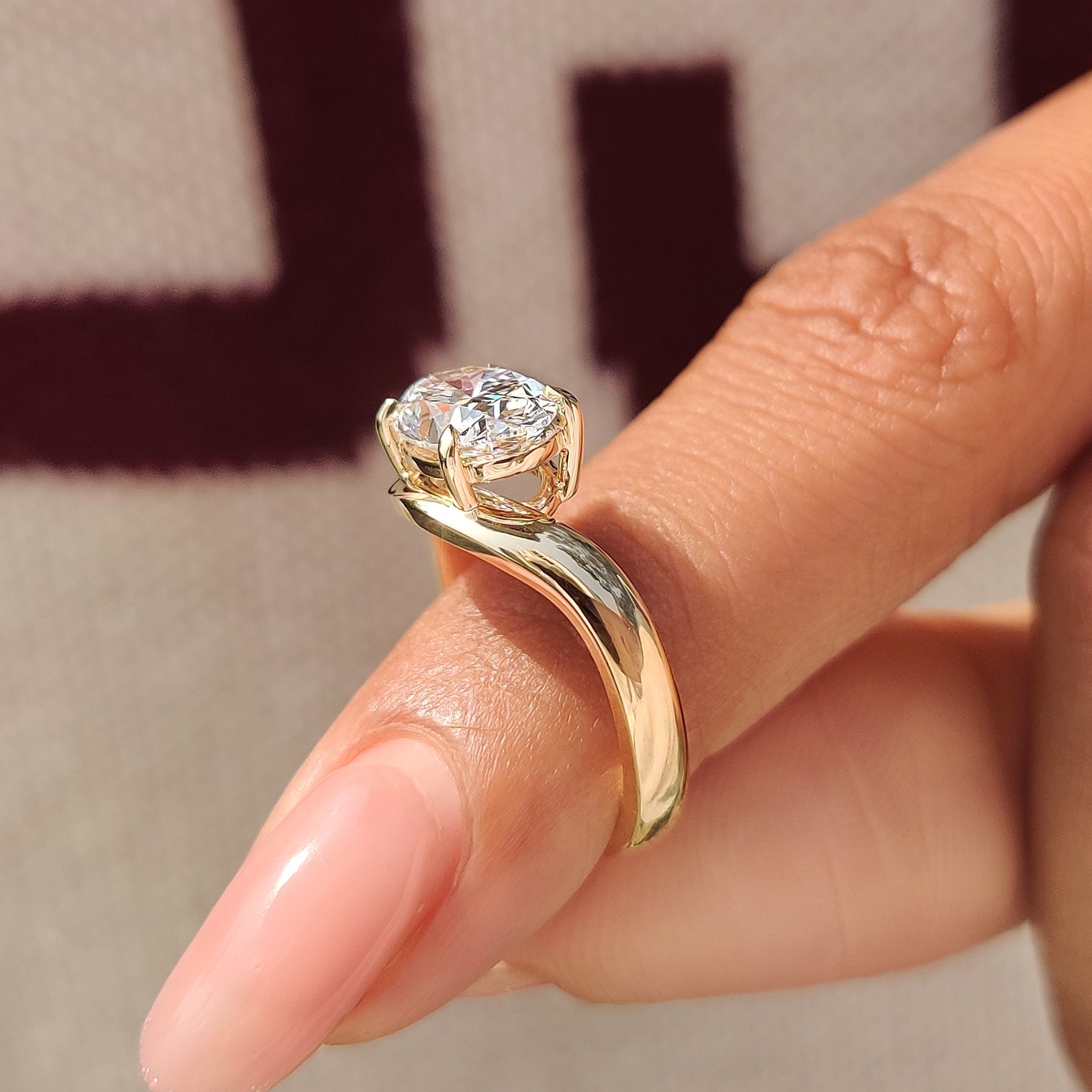 Oval cut diamond ring featuring lab grown diamond center
