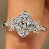 Oval cut diamond ring with marquise side stones design
