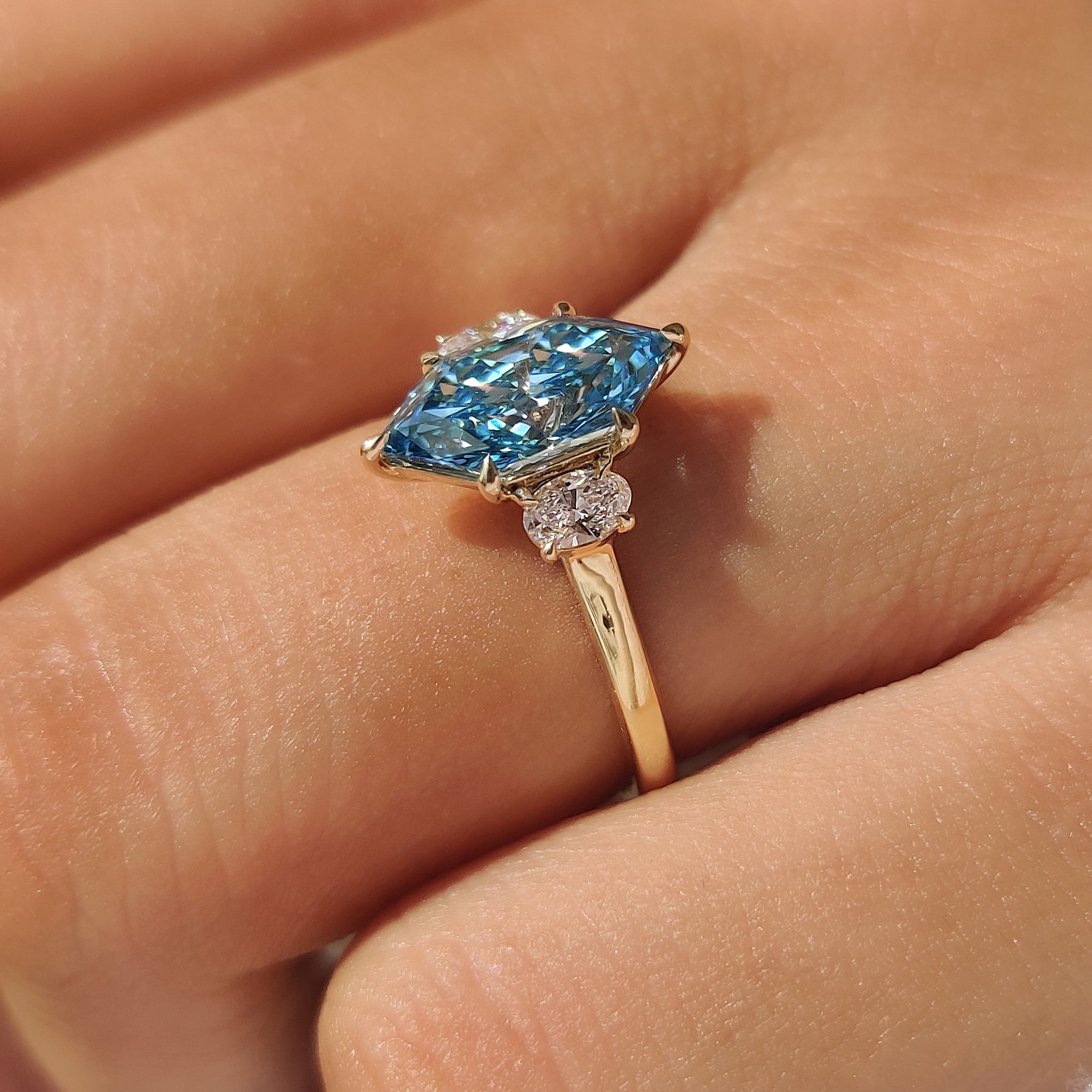 Trilogy ring with lab grown blue Dutch marquise diamond.
